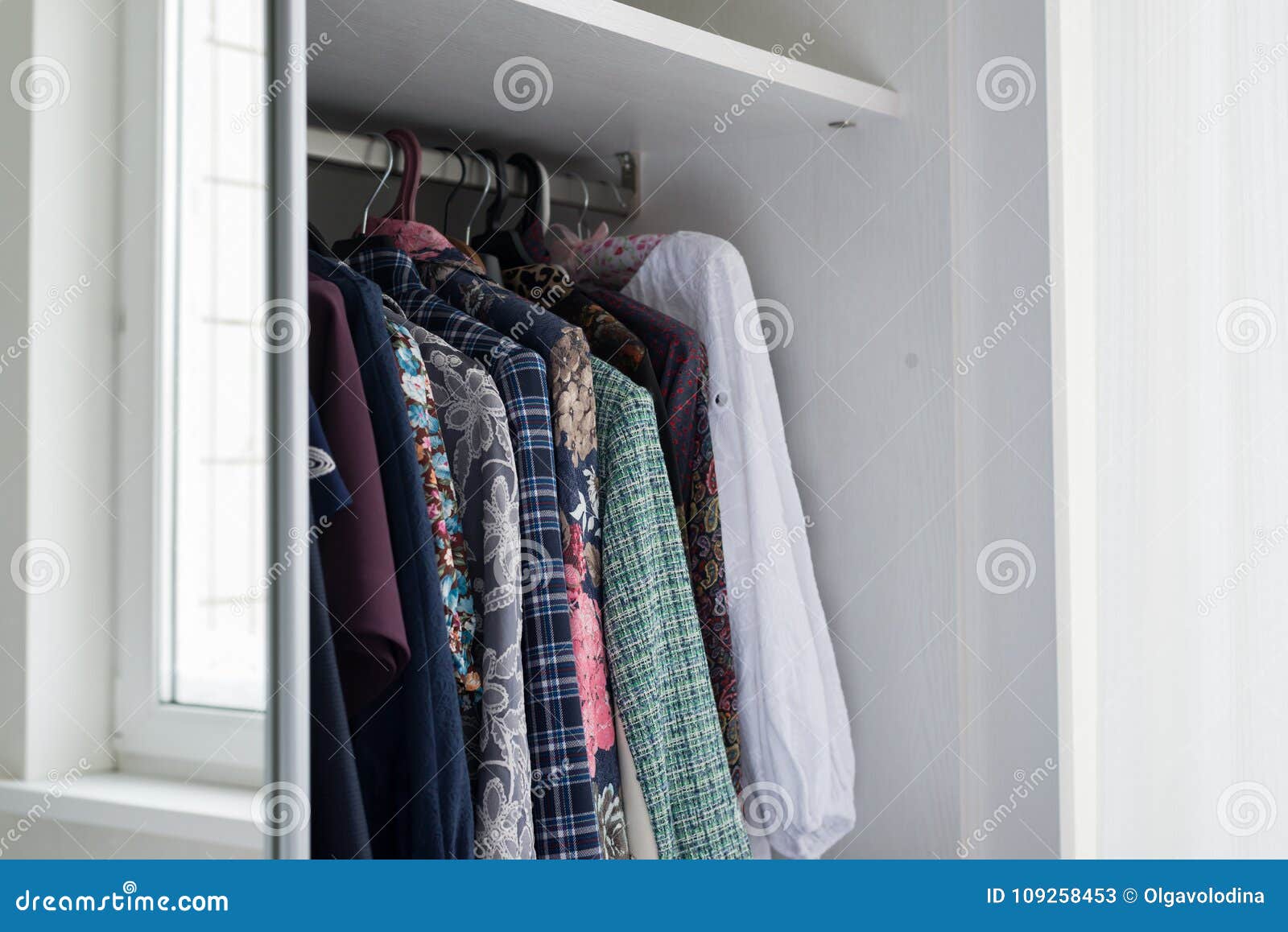Women X27 S Clothes Hanging In Open White Cabinet Stock Image