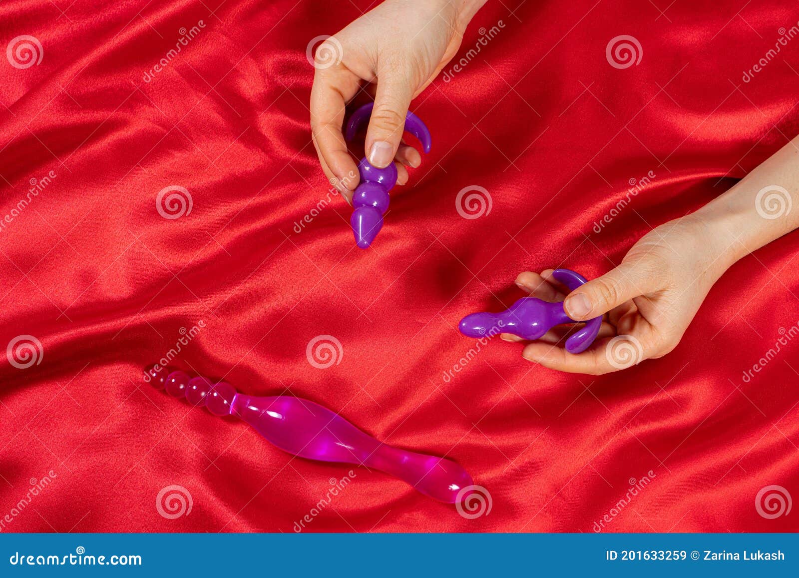 Women`s Hands, Anal on a Red Background