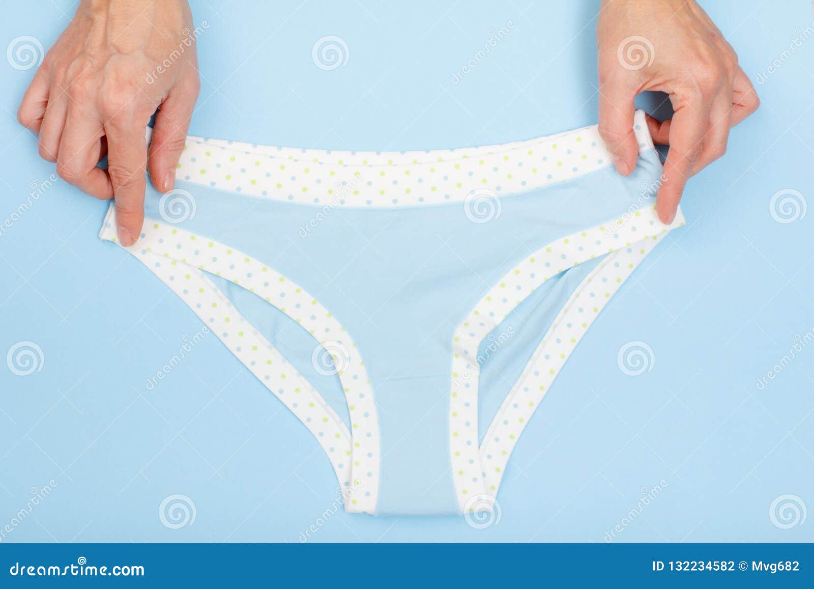 Women`s Hands with Beautiful Panties on Blue Background Stock Photo ...