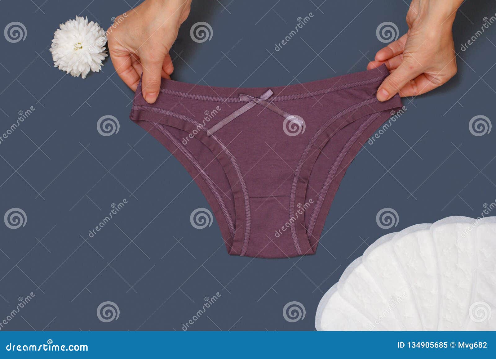 Women`s Hands with Beautiful Panties and Sanitary Pads on Gray ...