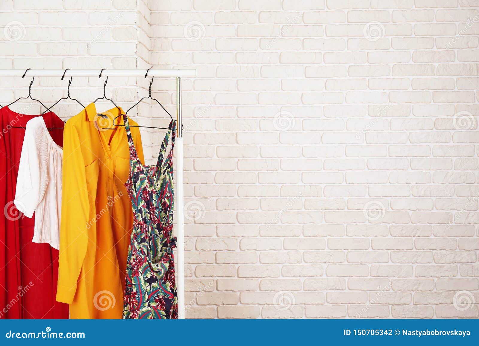 casual clothing boutique store rack with multiple dresses.