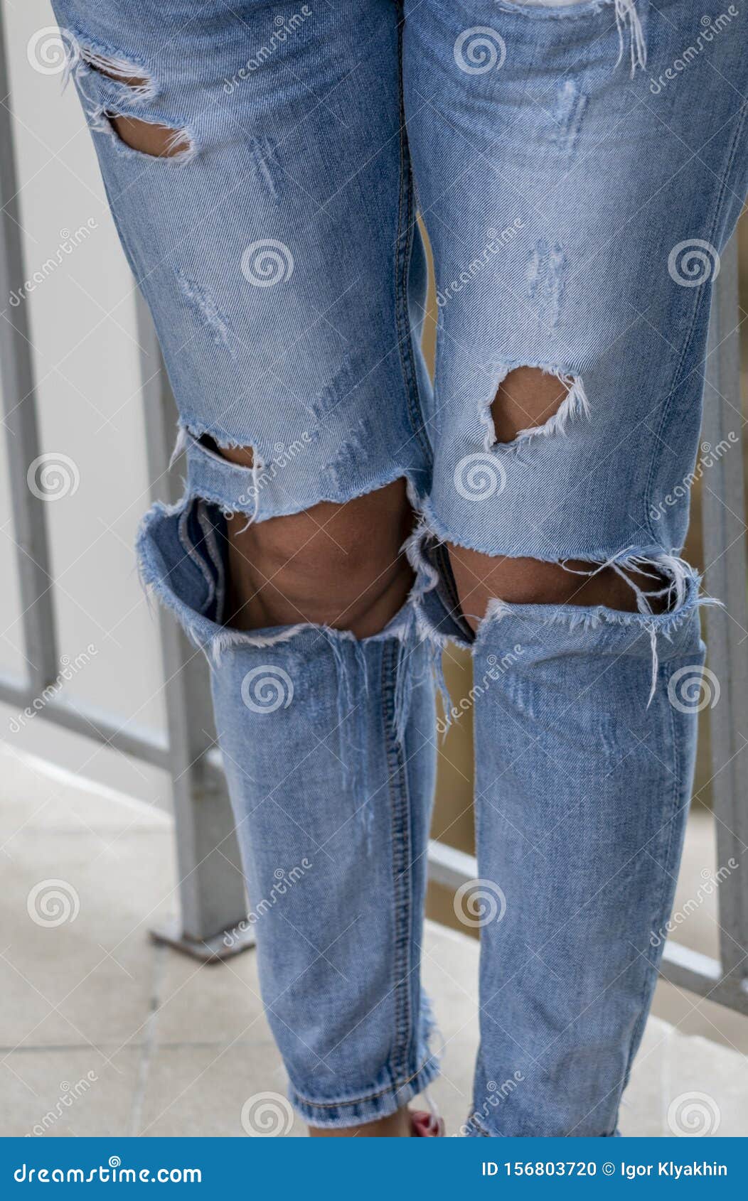 Women`s Legs Dressed in Jeans with Holes Stock Photo - Image of ...
