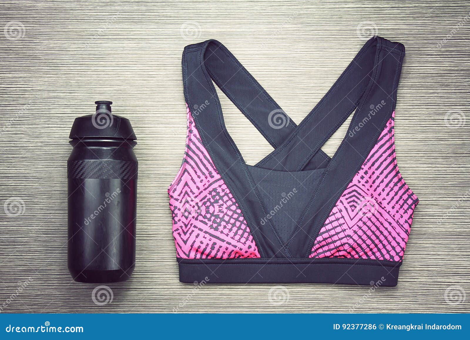 Women`s Sports Bra and Black Bicycle Water Bottle. Sport