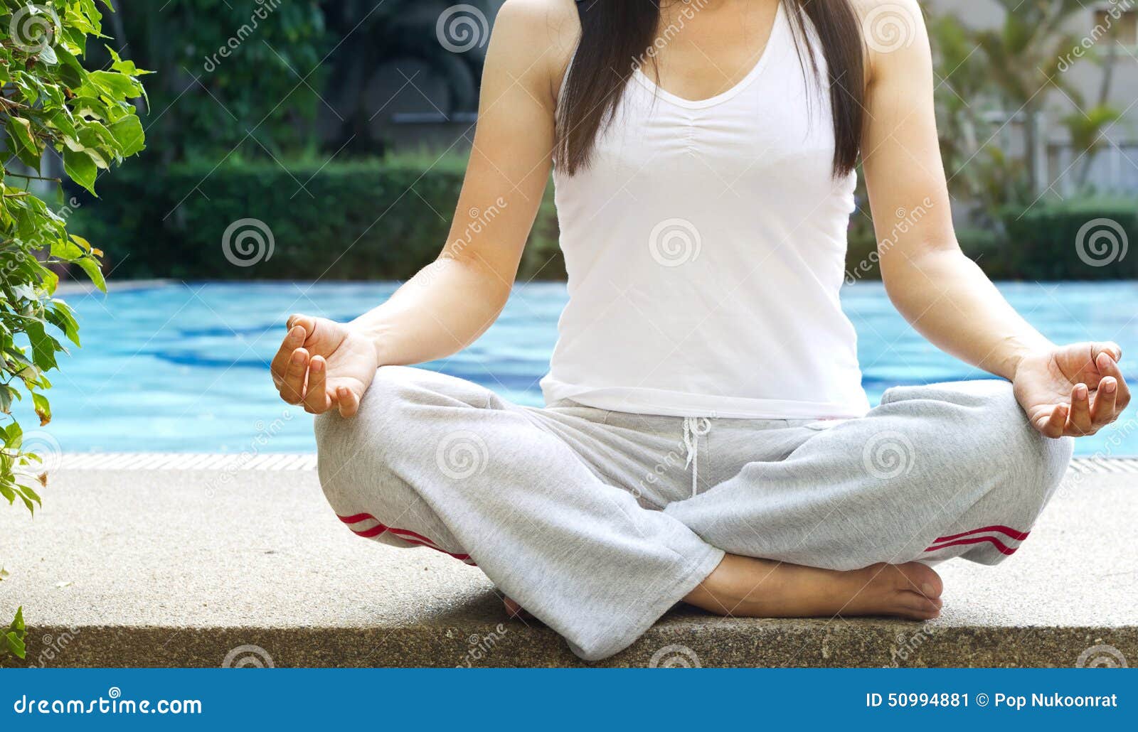 women siting meditation on swimming pool background