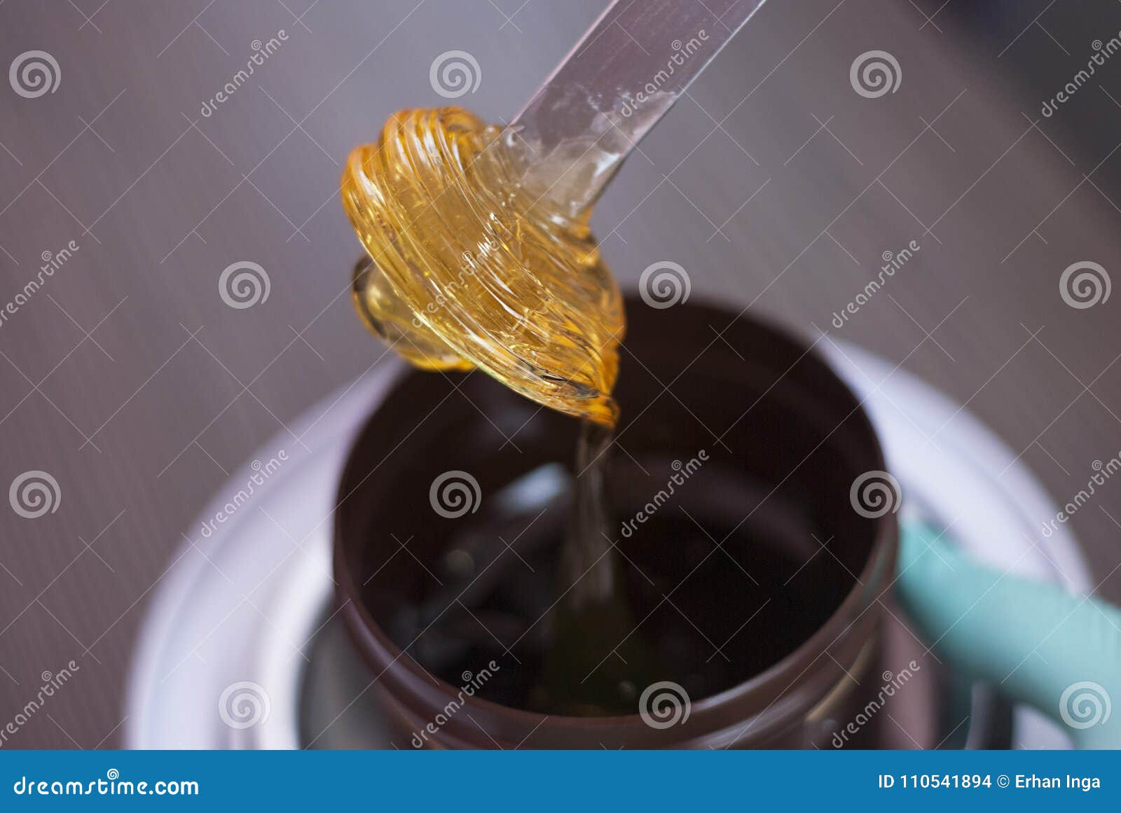 a women takes out from the jar a pasta for a sugaring, yellow color. depilatory sugar paste. beauty and cosmetics.