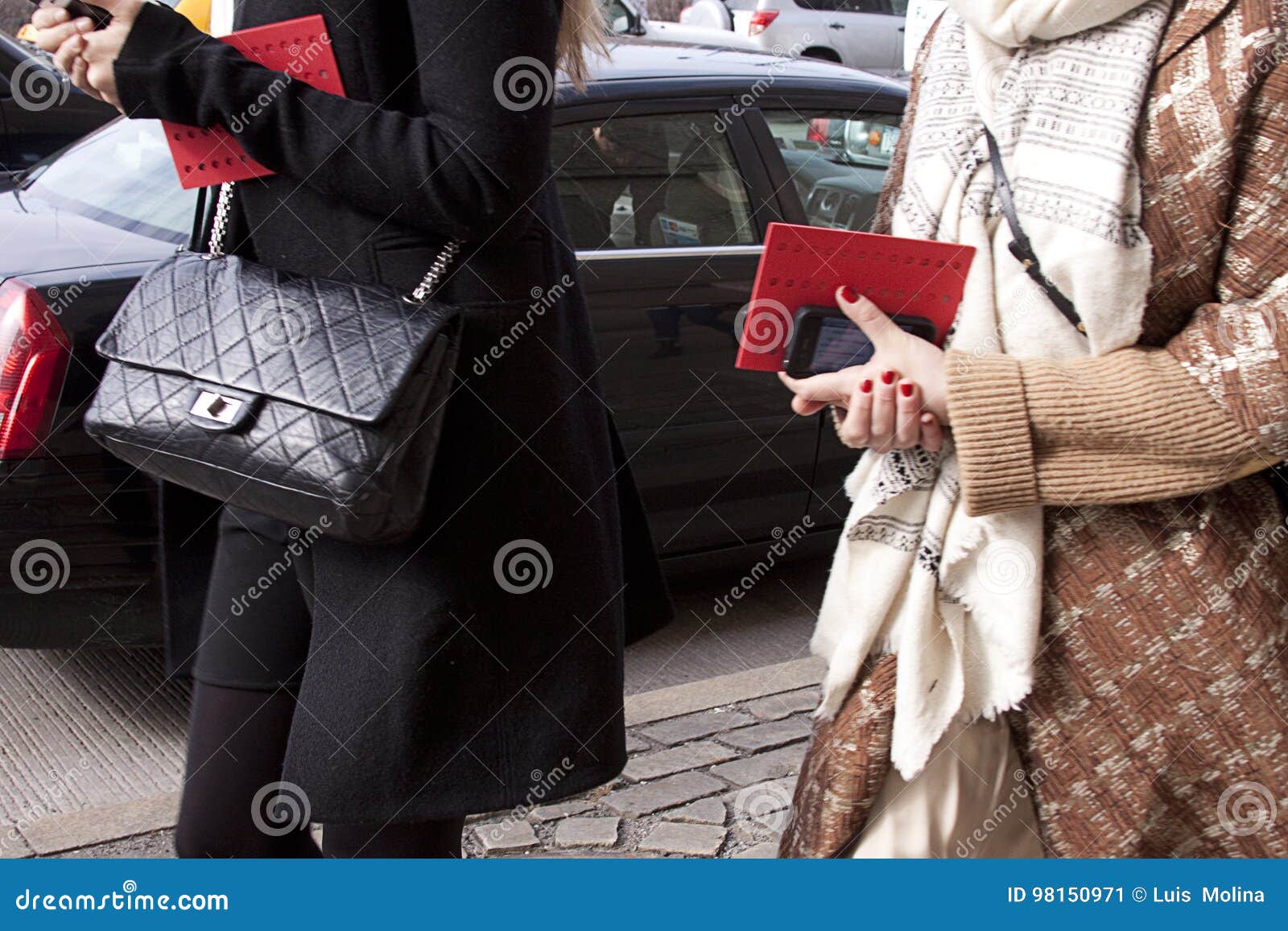  Woman walking in the street holding fashion handbag