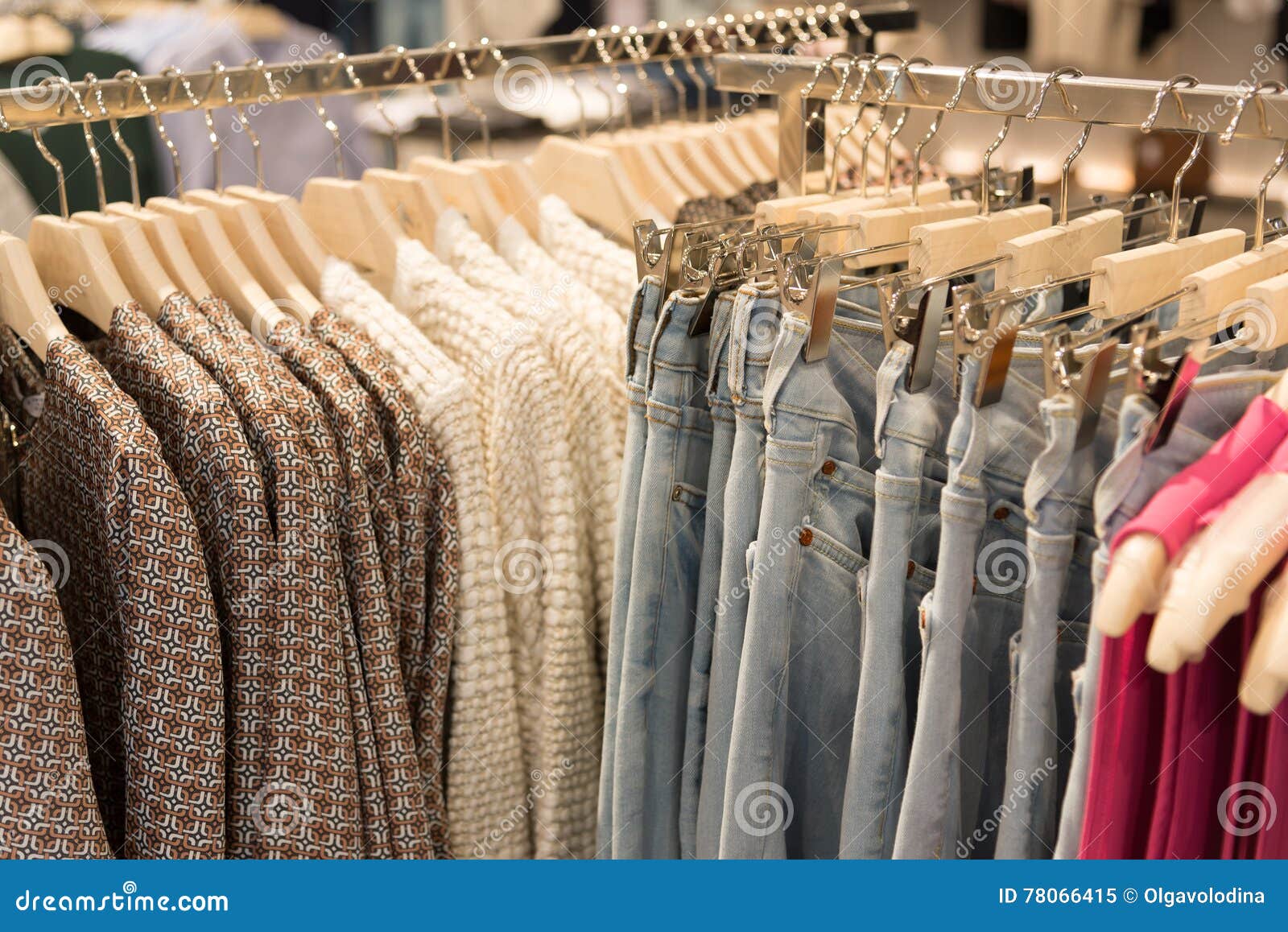 Womens Clothes and Jeans are Hanging on Hangers in Store Stock Image