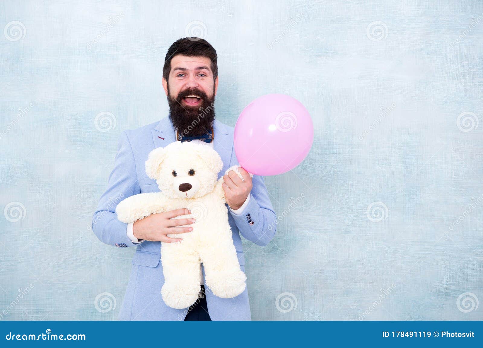 womens day. greetings 8 march. stereotypical gifts. valentines day. romantic man with teddy bear and air balloon waiting