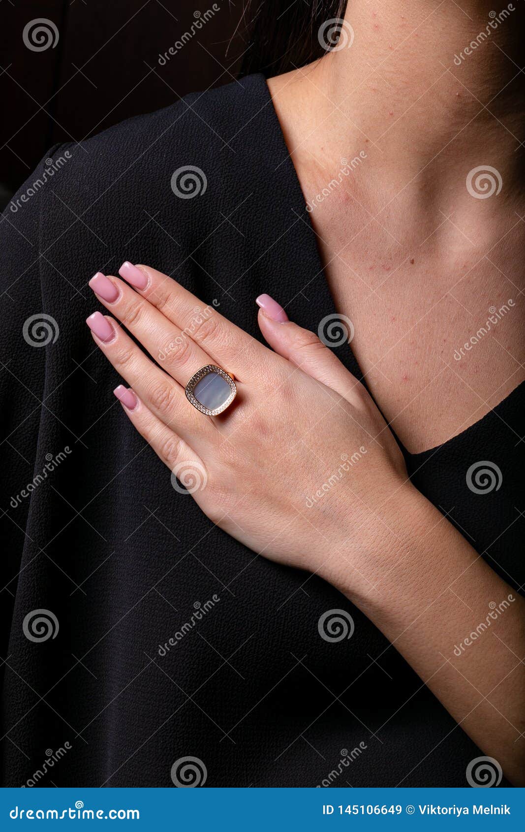 Womens Gold Ring with a Diamonds Fringe, with Stones in the Middle on Finger,  on a Black Background. Stock Image - Image of background, design: 145106649