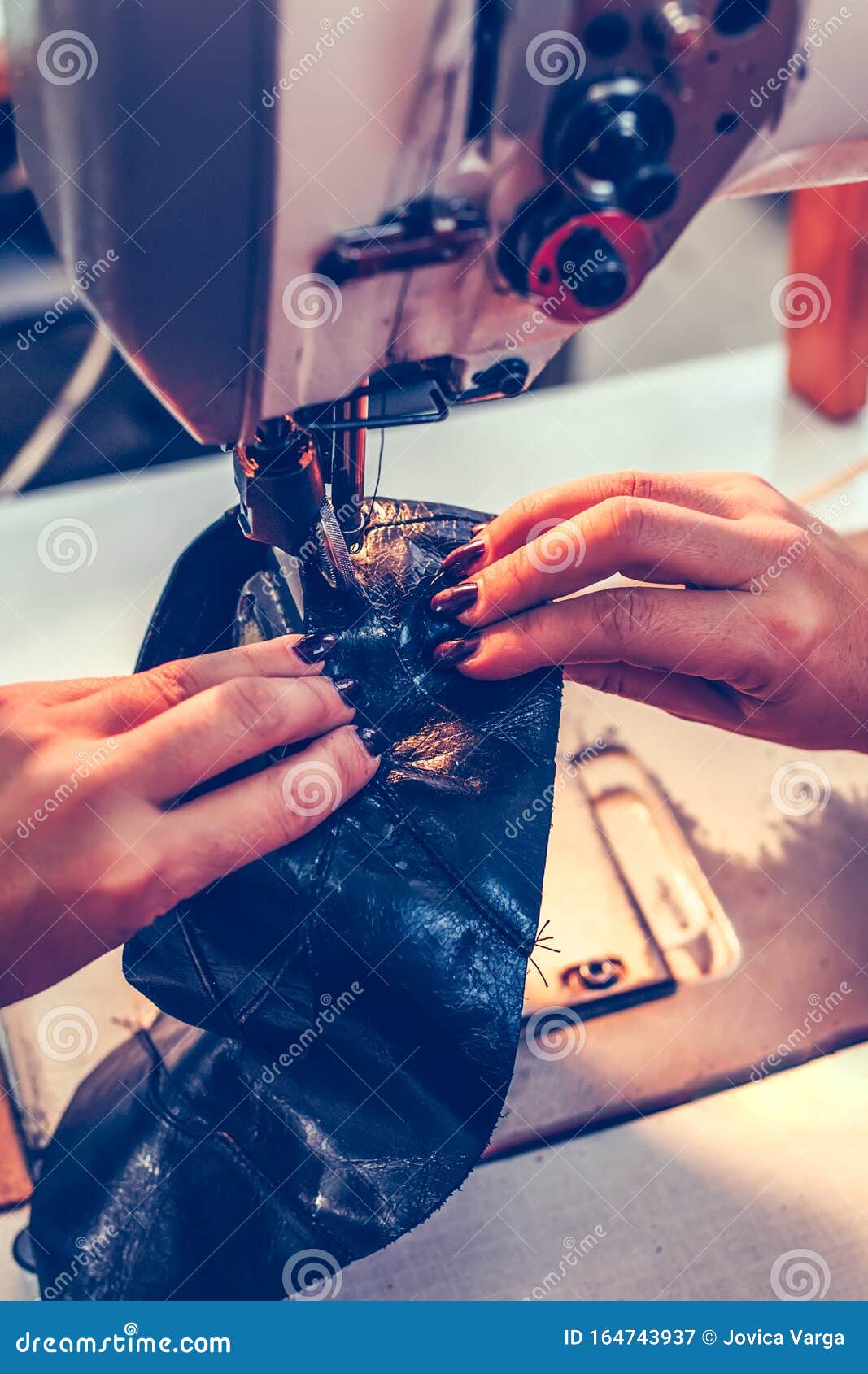 Wonan Hands Stitching a Part of the Shoe at a Stock Image