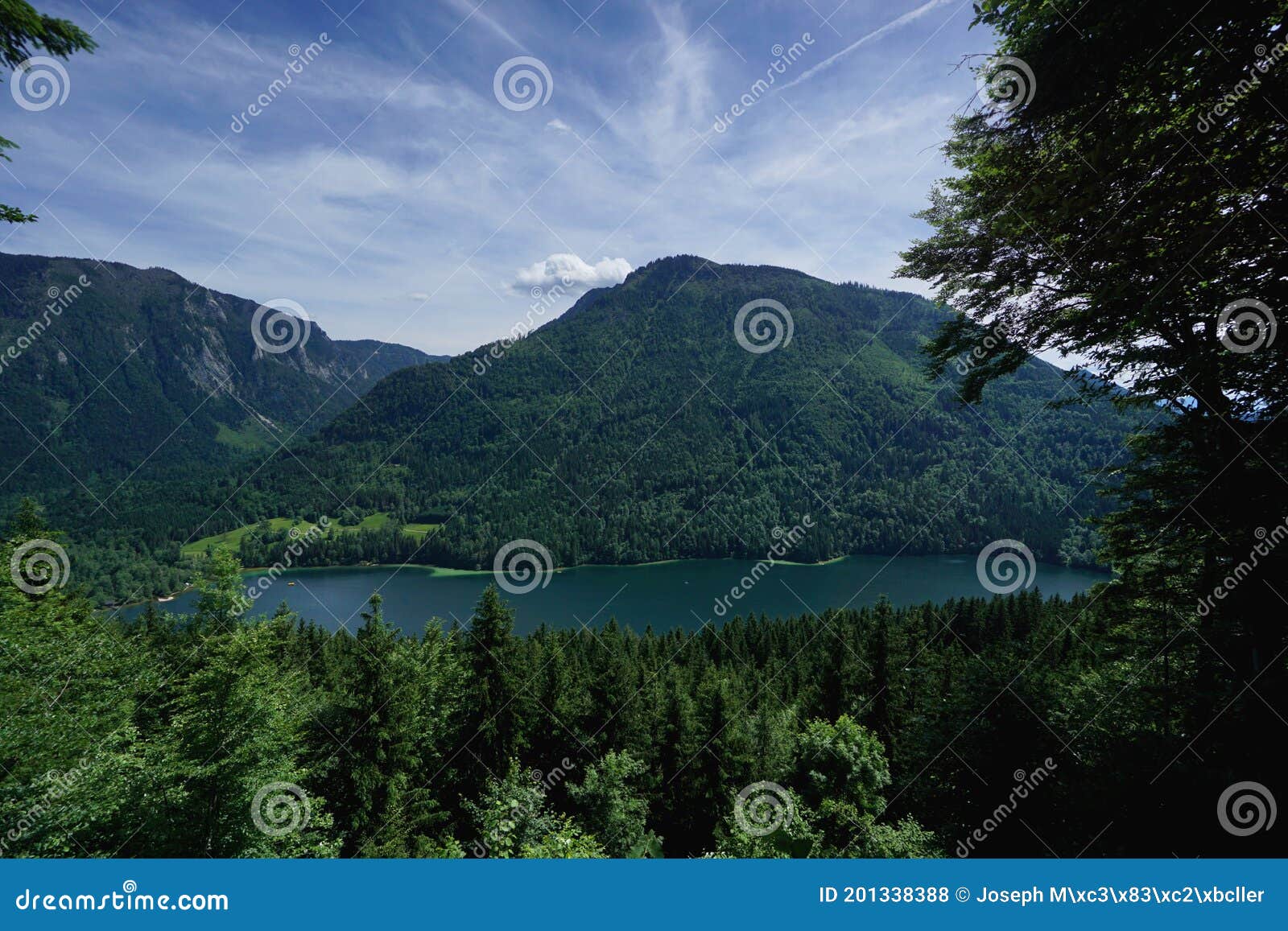 wonderful day in the mountains: beautiful lake in the mountains / surrounded by lots of green trees