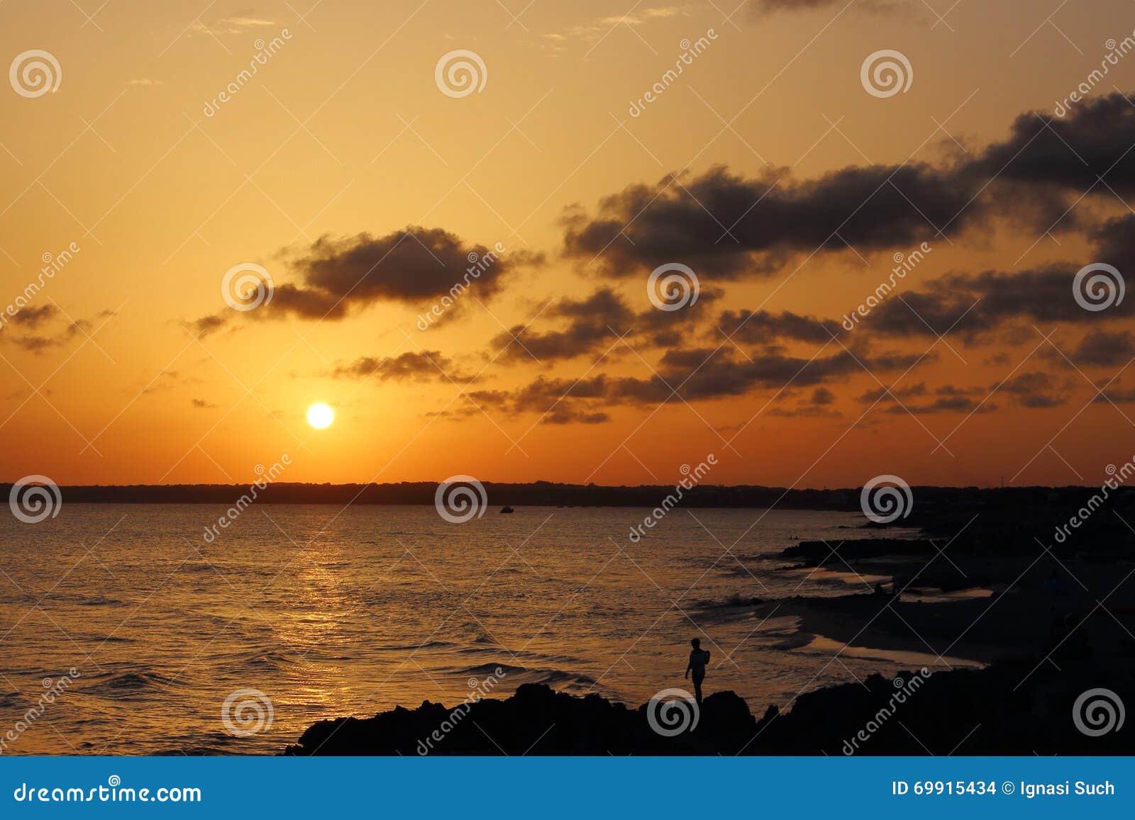 wonderful sunset celebrated by one person at pirata bus bar in formentera, balearicislands, spain