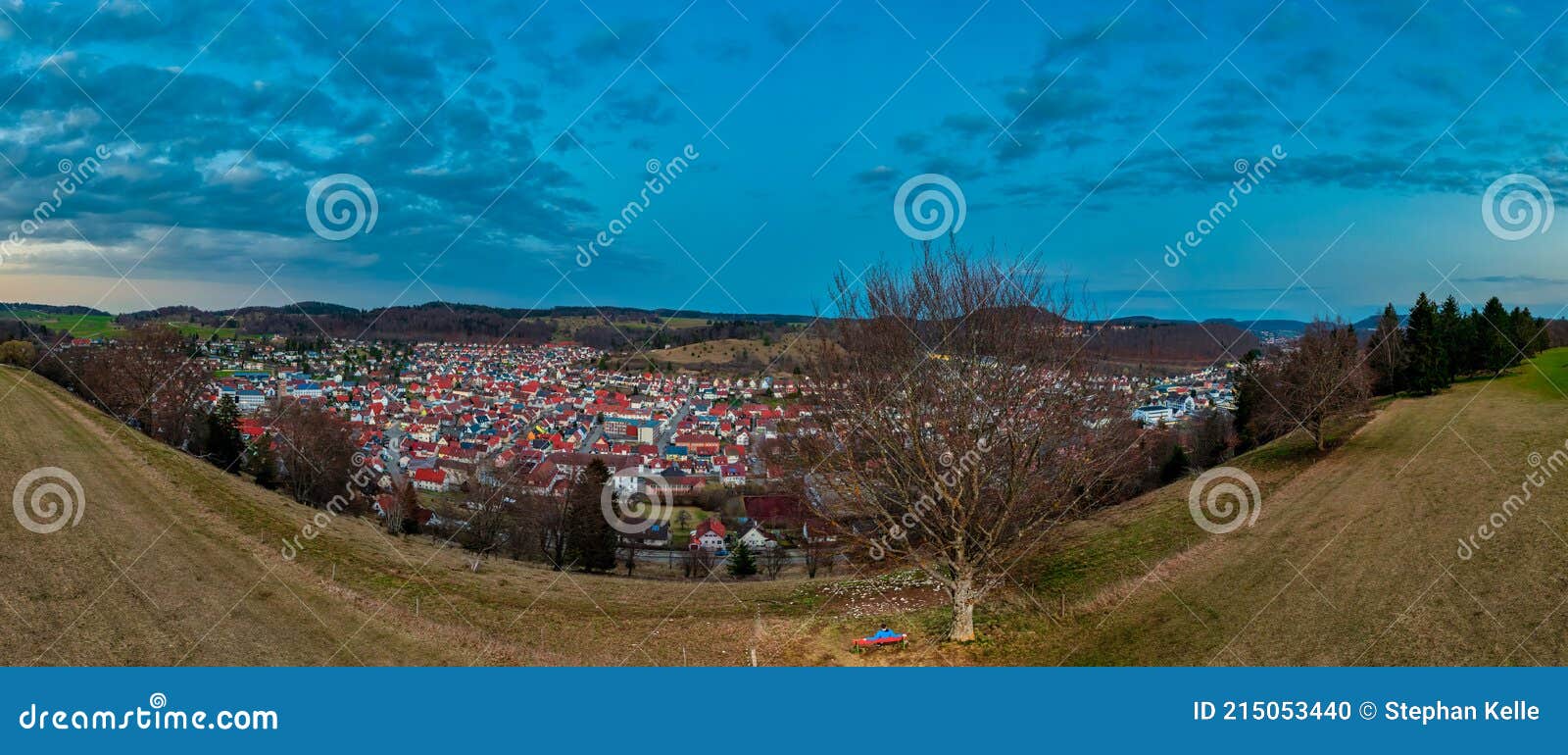 wonderful view over the swabian alb and its city albstadt as a panoramic drone shot at the evening atmophere with a man