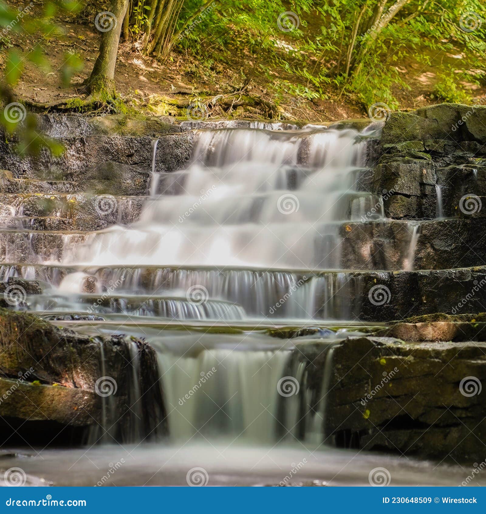 wonderous waterfall in rocks in a fall forest