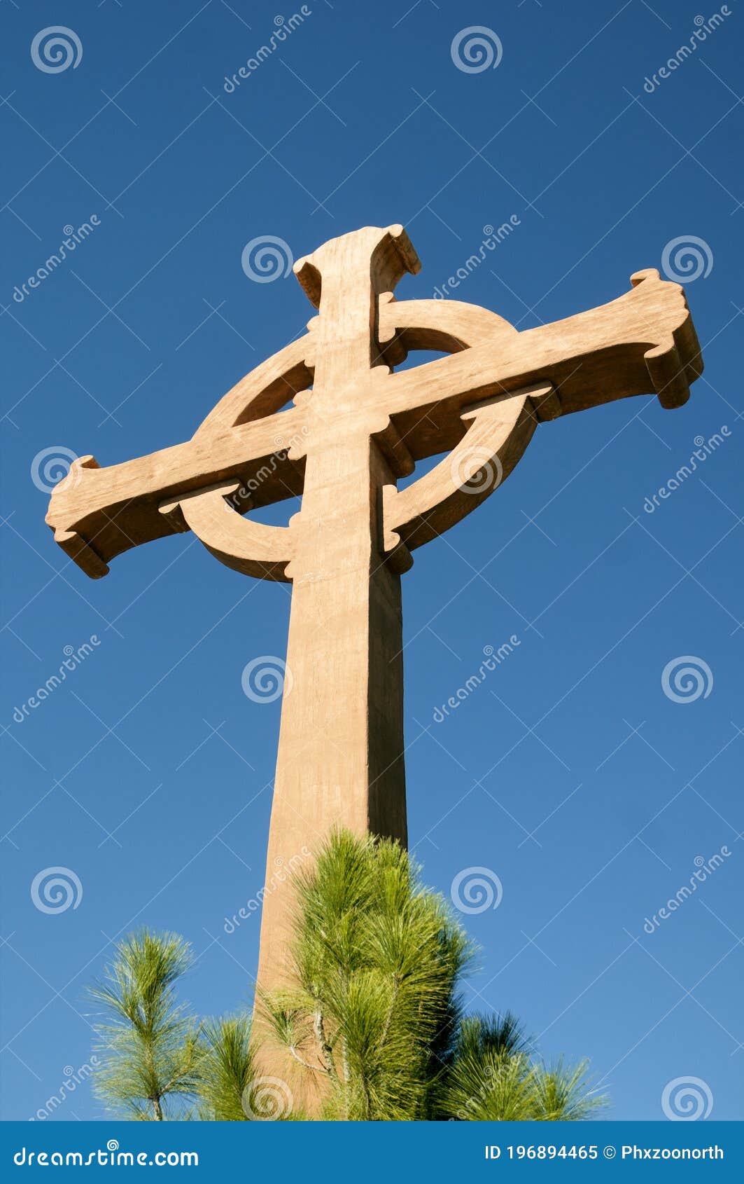 wood cross at monastery backed by blue sky
