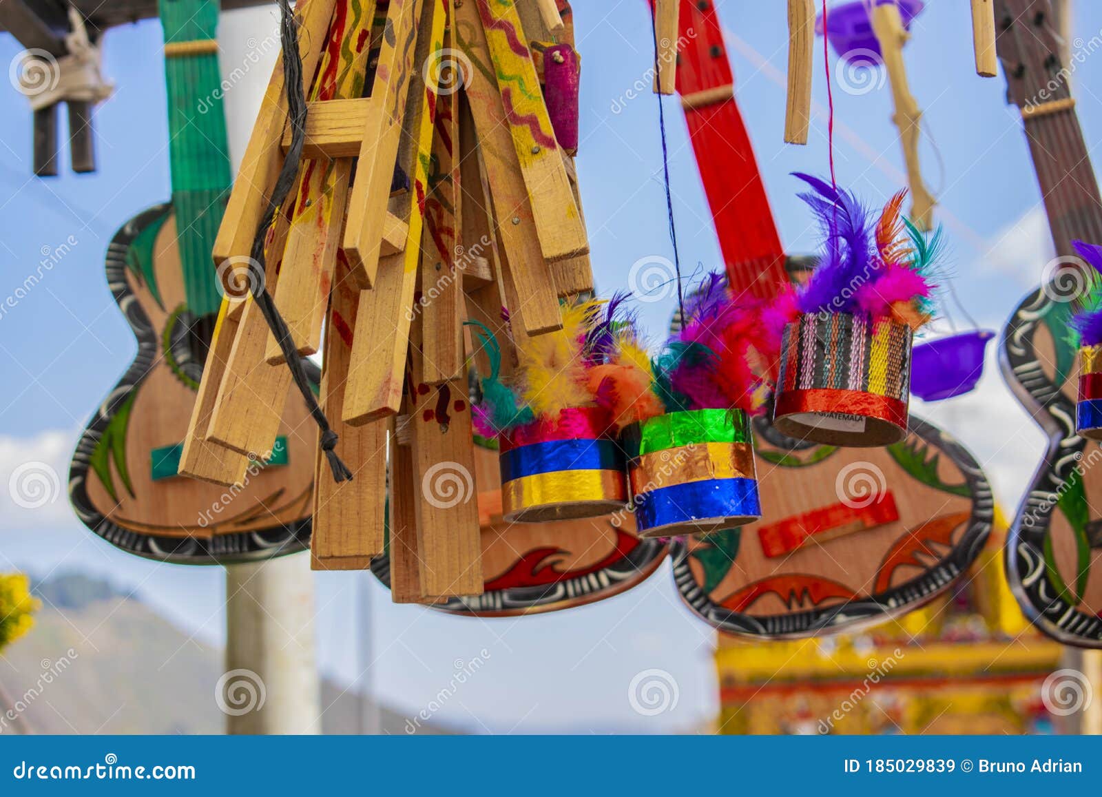 wood painted in colors with colored feathers, and hanging guitars fair of san andres xecul