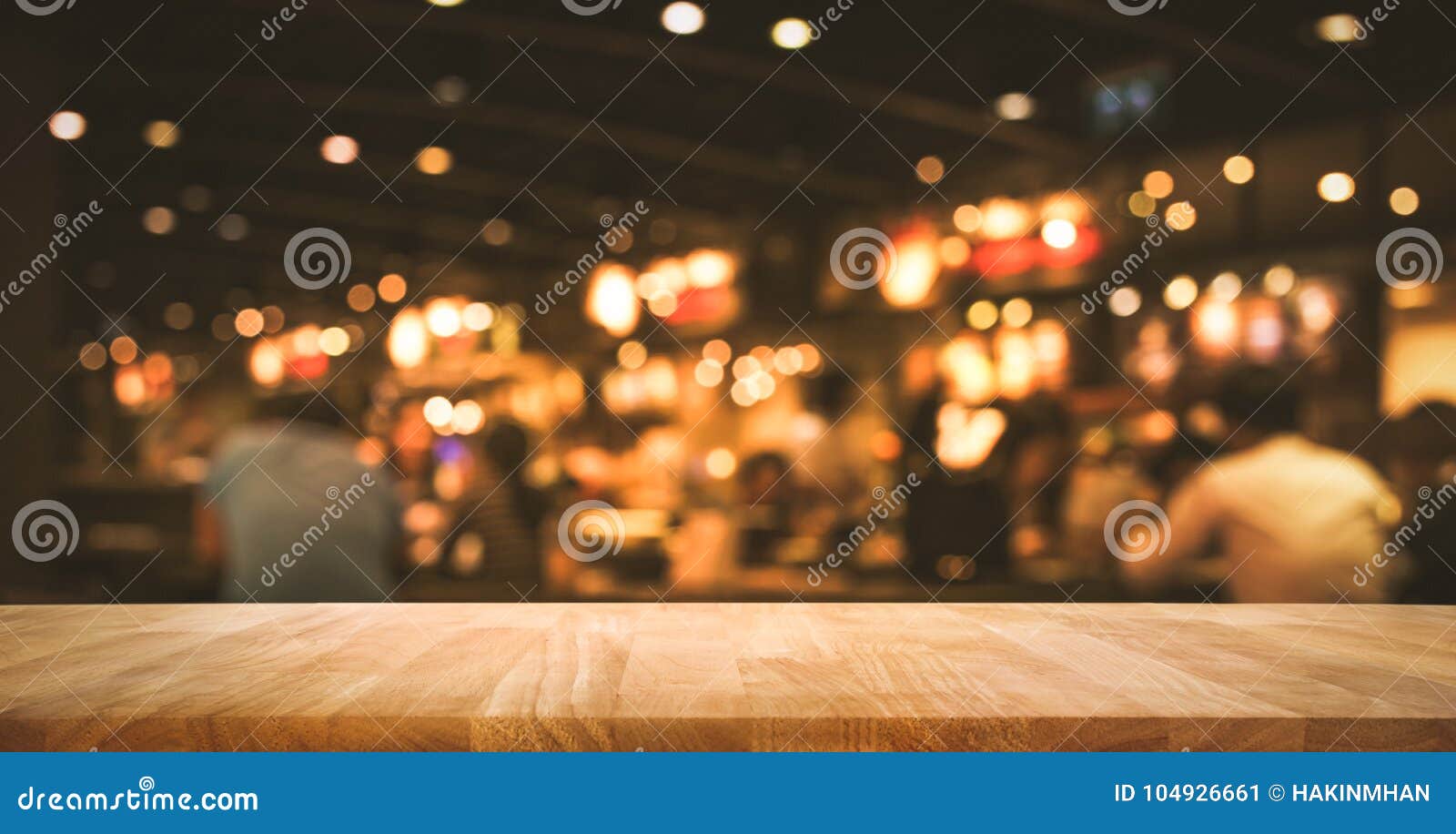 wood table top bar with blur light bokeh in dark night cafe