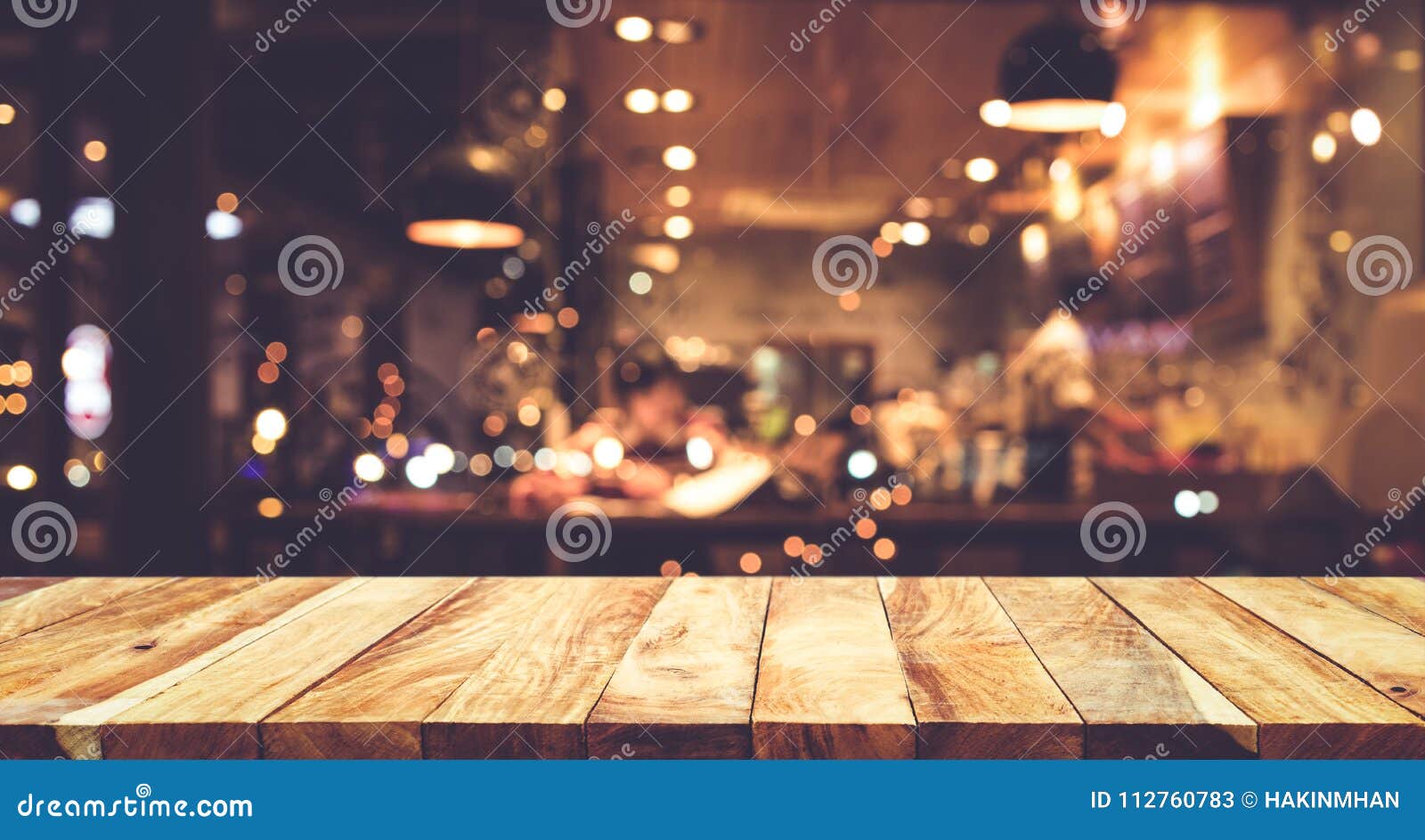 wood table top bar with blur night cafe background