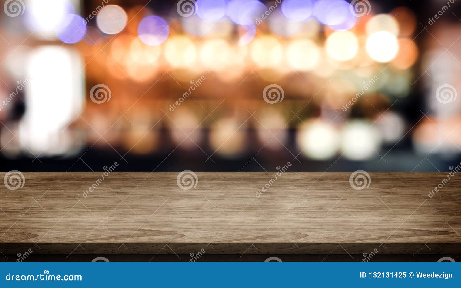 wood table top with blur nightclub bar counter with bokeh light