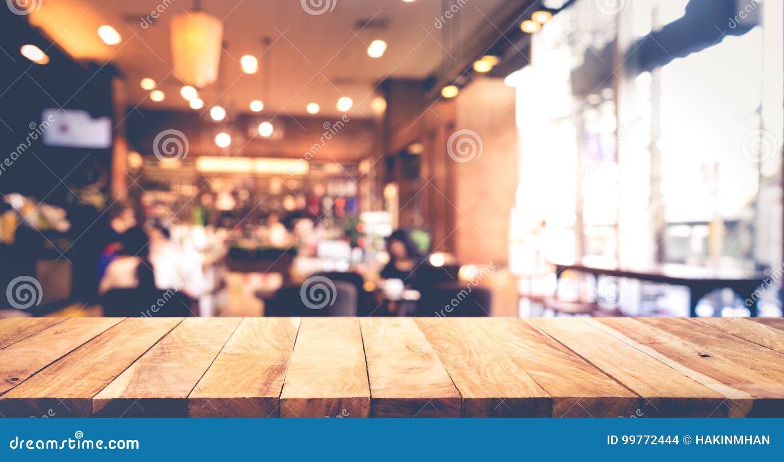 wood table top with blur of people in coffee shop or cafe,restaurant