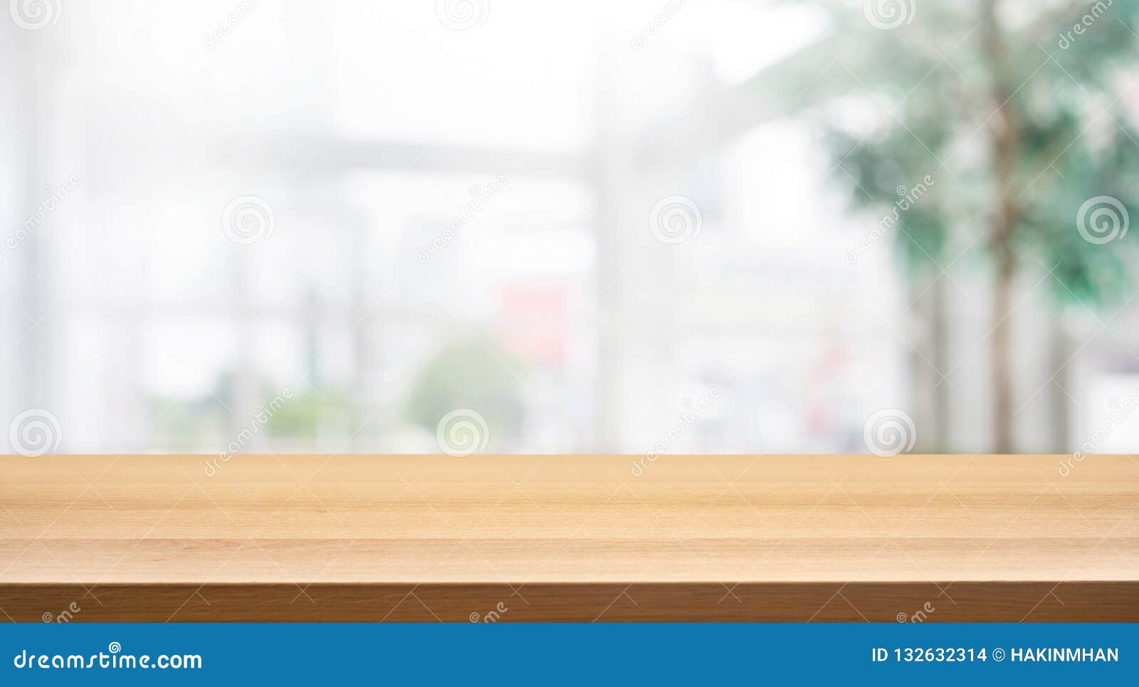 wood table top on blur white glass wall background form office building