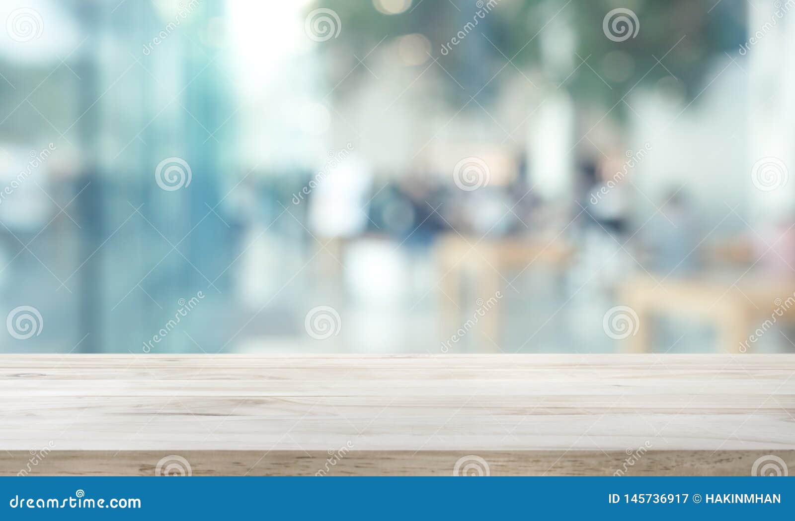 wood table top on blur window glass,wall background with city view.for montage product display or  key visual