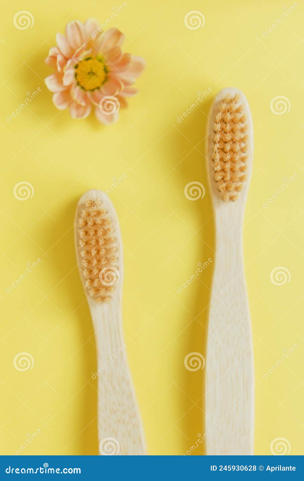 wooden bamboo toothbrush on yellow background