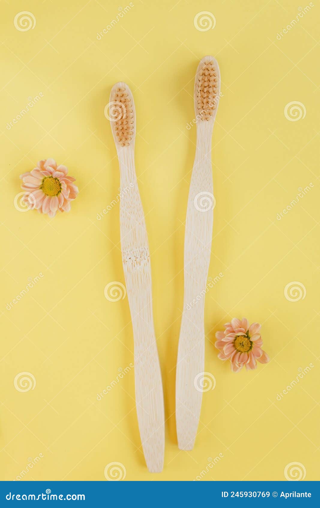 wooden bamboo toothbrush on yellow background