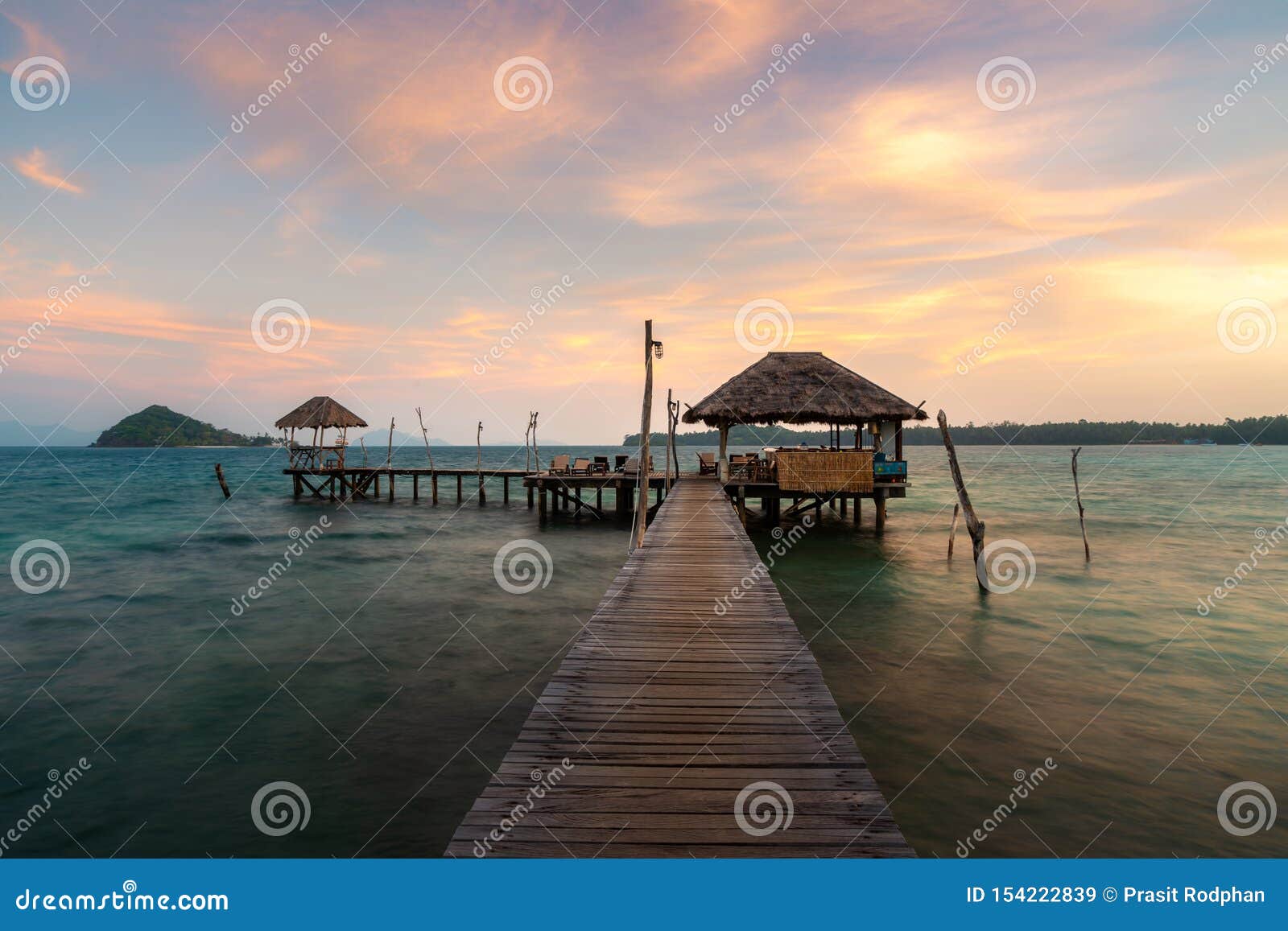 wooden bar in sea and hut with dramatic sunset sky in koh mak at trat, thailand. summer, travel, vacation and holiday concept
