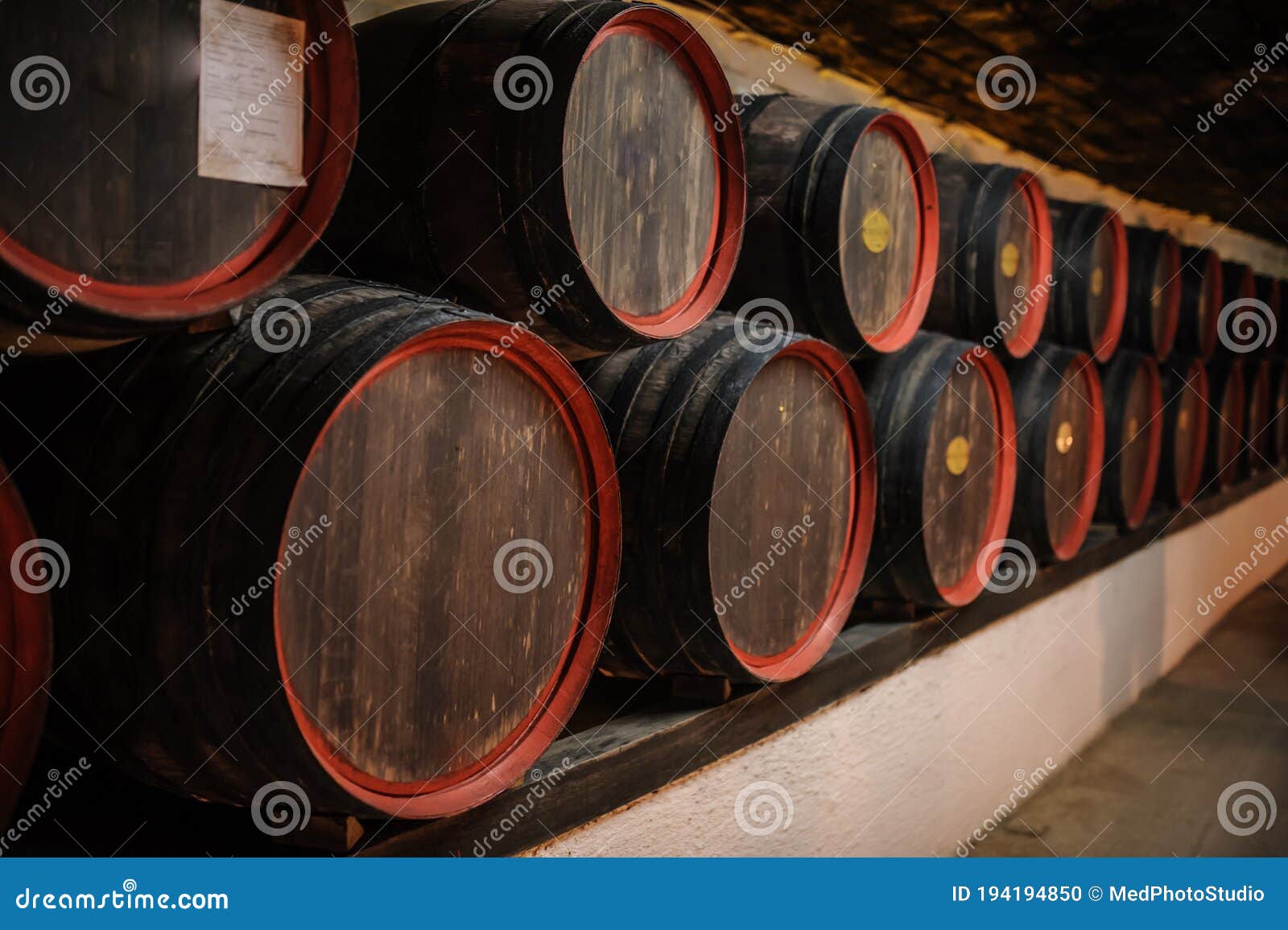 Wooden Barrels Inside the Underground Tunnels of a Winery Stock Photo