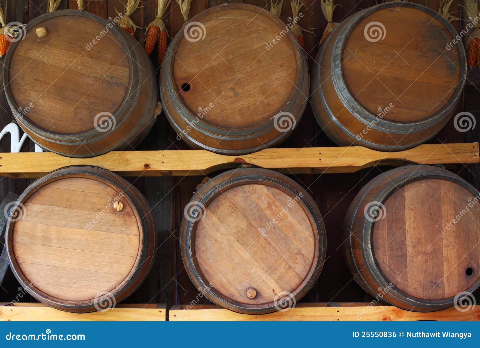 Wooden barrels on a rack. stock photo. Image of front 25550836
