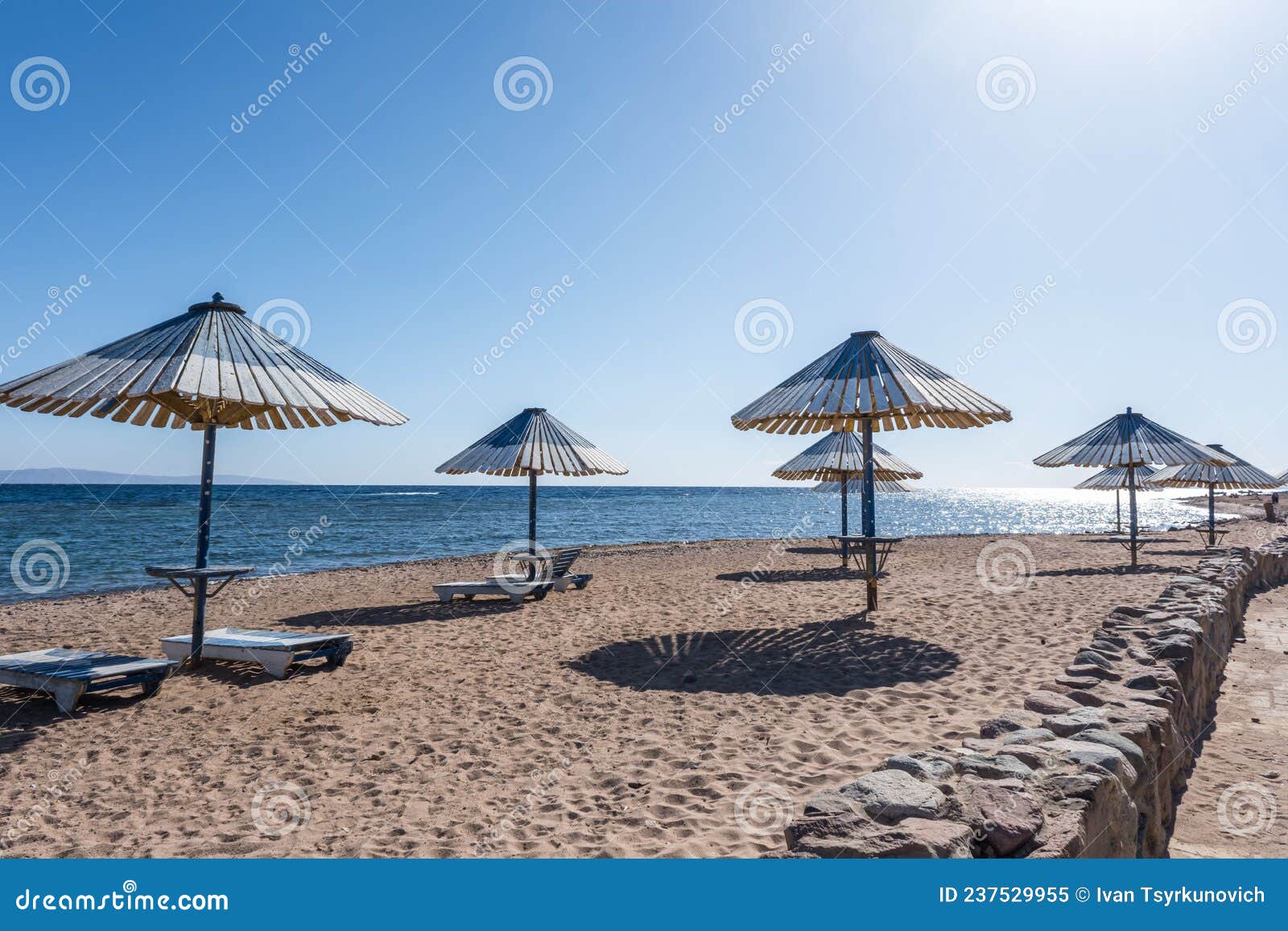 Wooden Beach Umbrellas and Sun Loungers by the Red Sea in Bright Sunny ...
