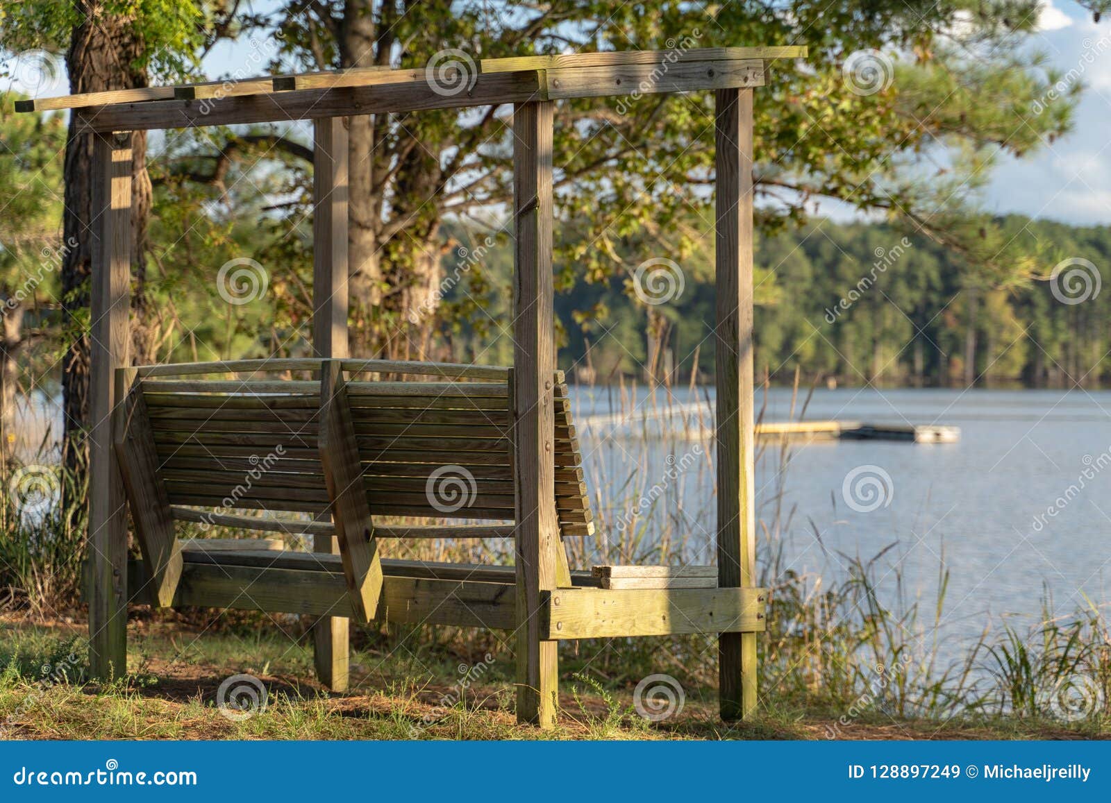 Wooden Bench Overlooking Lake And Boat Dock Stock Image 