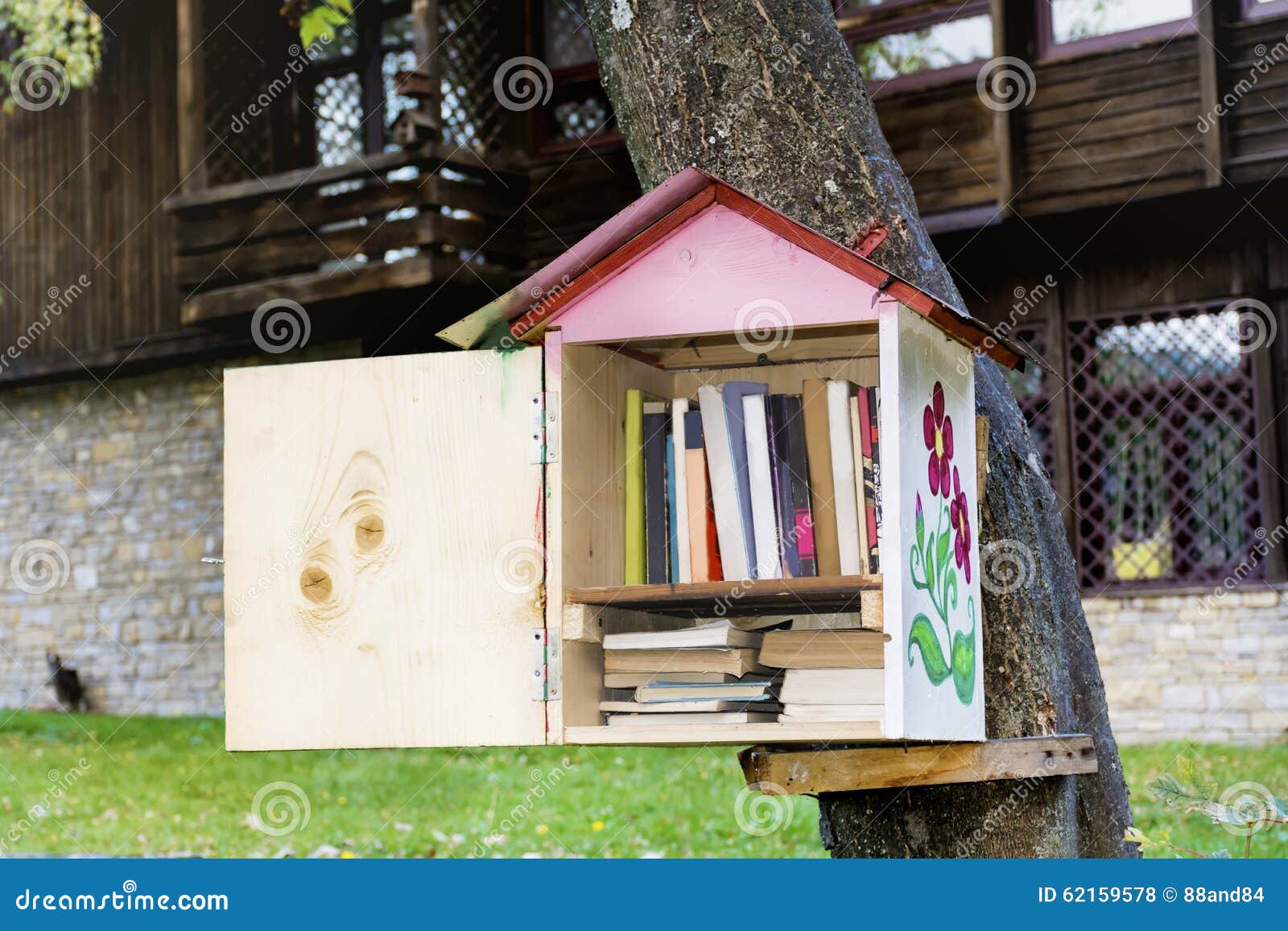 Wooden Bird House With Books Reading Outdoor Stock Photo