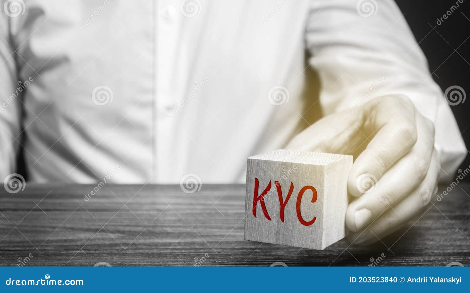 wooden block with the word kyc - know your customer / client. verify the identity, suitability and risks involved with maintaining