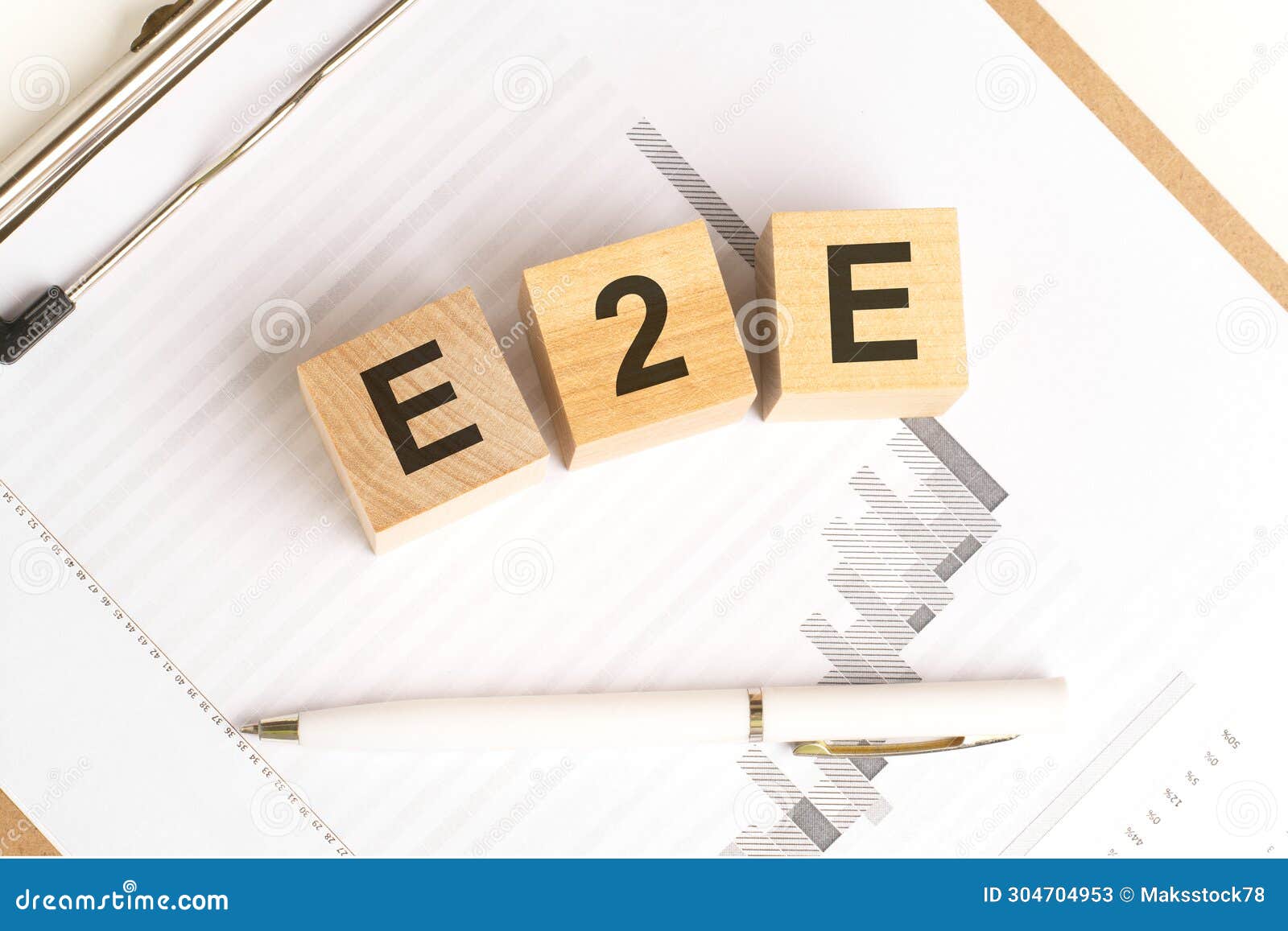 wooden blocks with the word e2e stand on financial background with chart and pen, business concept