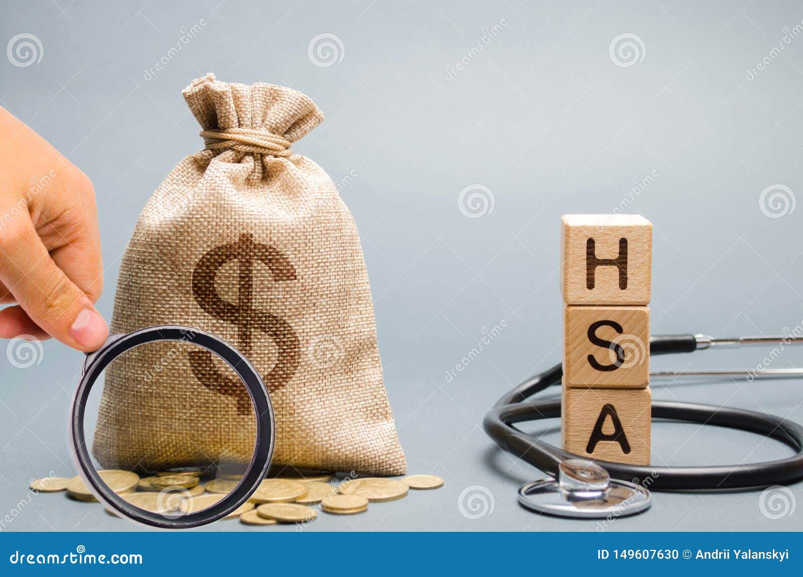 wooden blocks with the word hsa and money bag with stethoscope. health savings account. health care. health insurance. investments