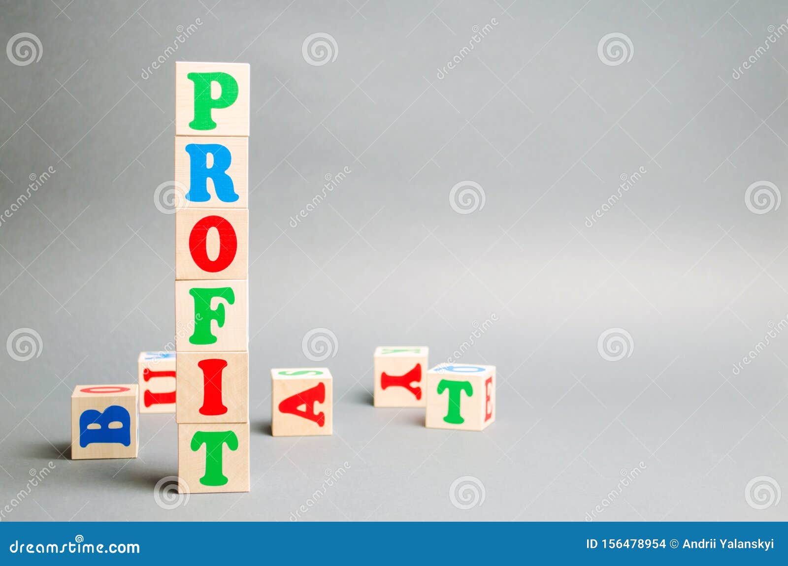 wooden blocks with the word profit and randomly scattered cubes. the financial result of the company for a certain period of time