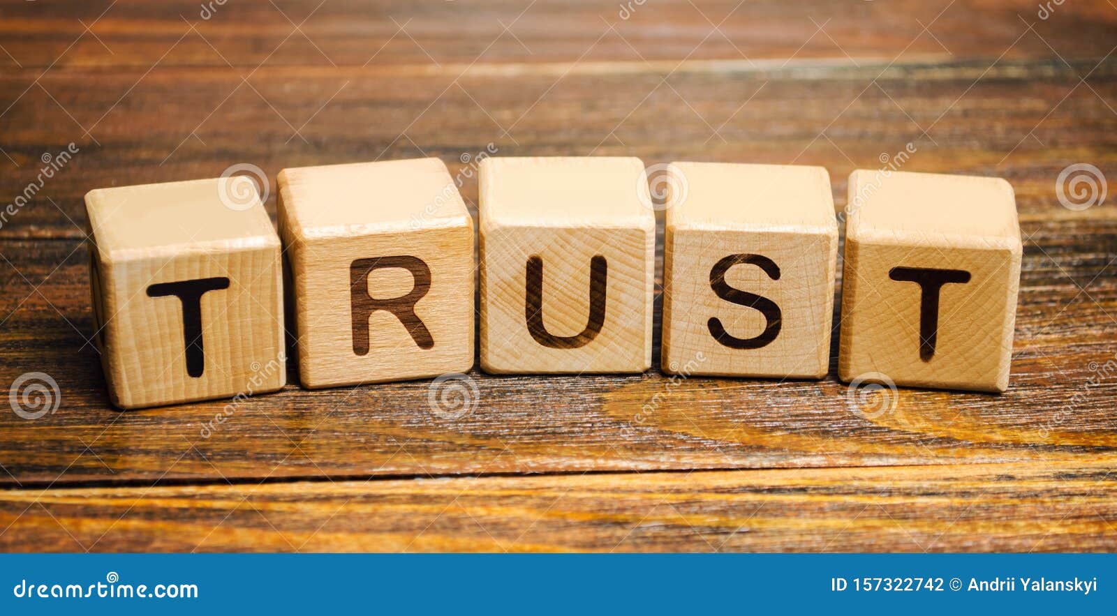 wooden blocks with the word trust. trust relationships between business partners, friends, relatives. respect and authority.