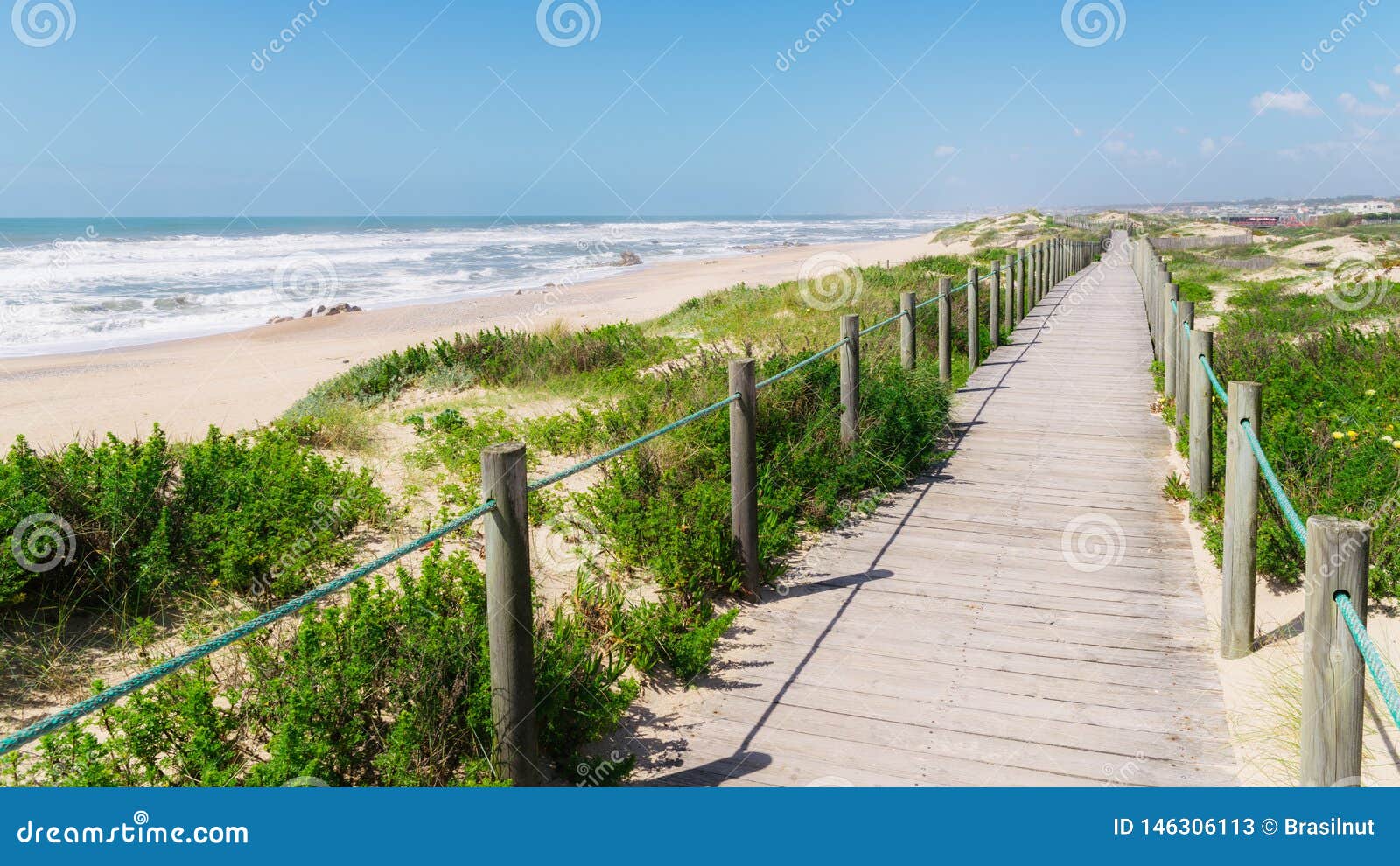 wooden boardwalk at the praia da frente azul, in english the blue beach front in the seaside resort espinho
