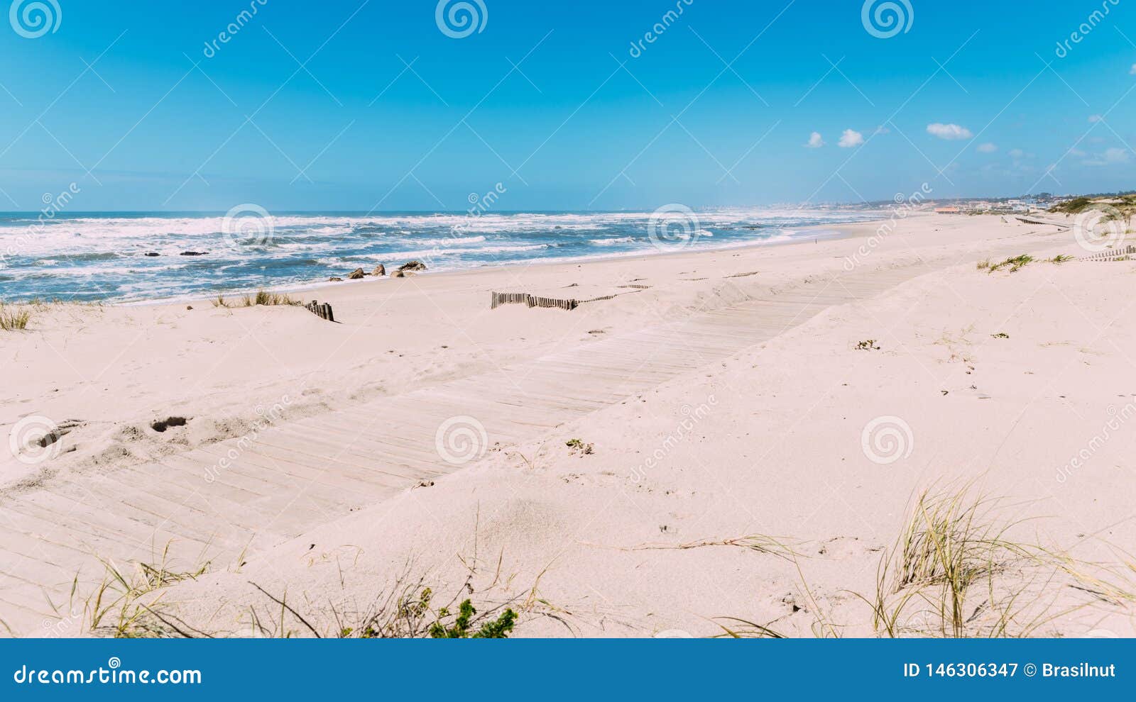 wooden boardwalk at the praia da frente azul, in english the blue beach front in the seaside resort espinho