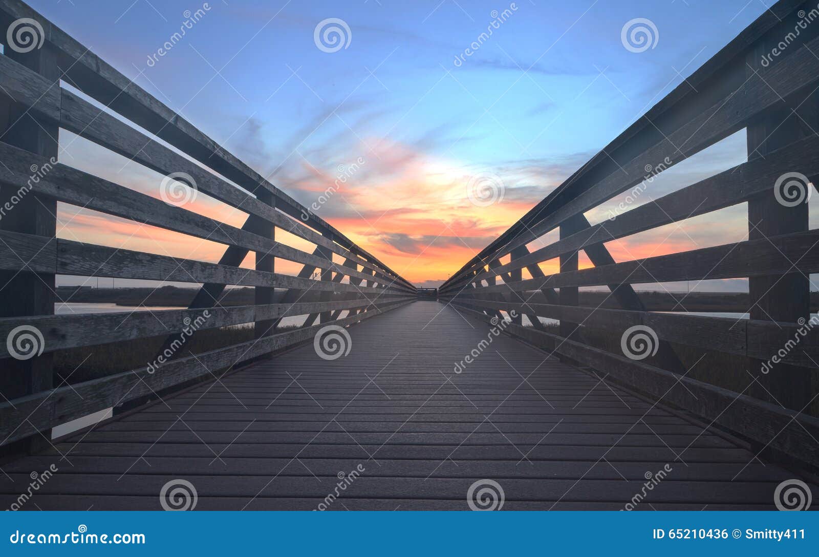 wooden boardwalk at sunset at bolsa chica