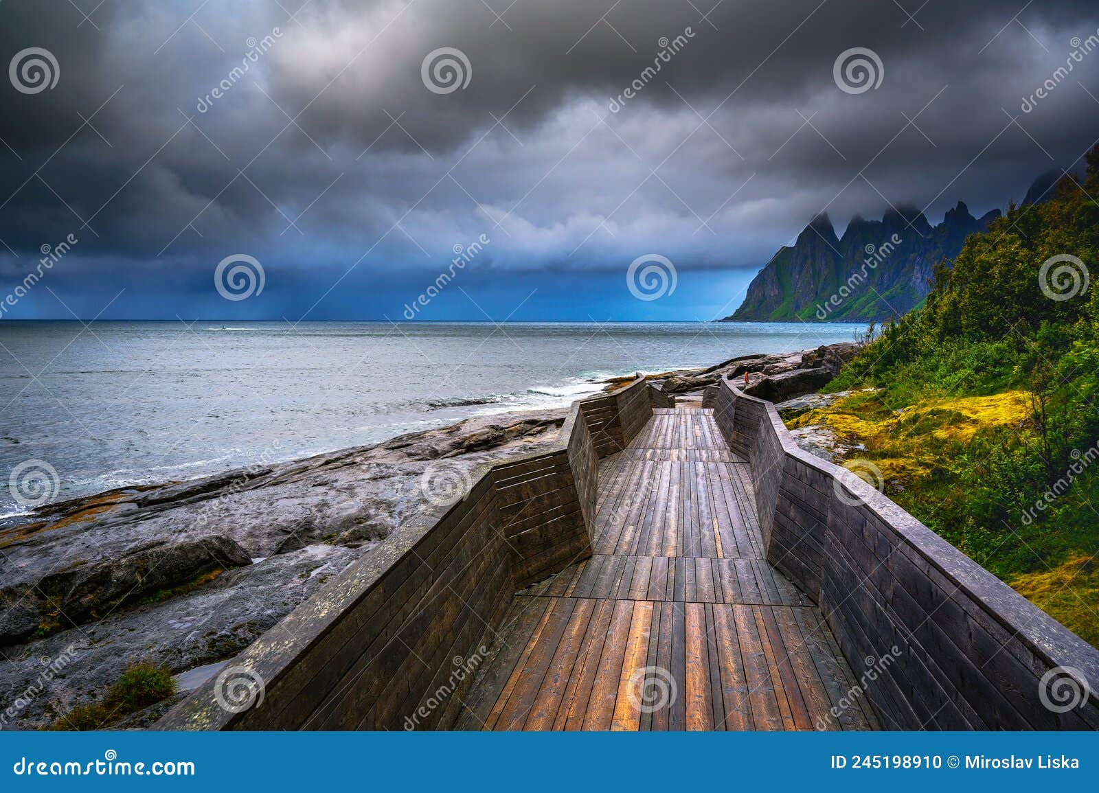 wooden boardwalk at tungeneset beach on senja island in northern norway