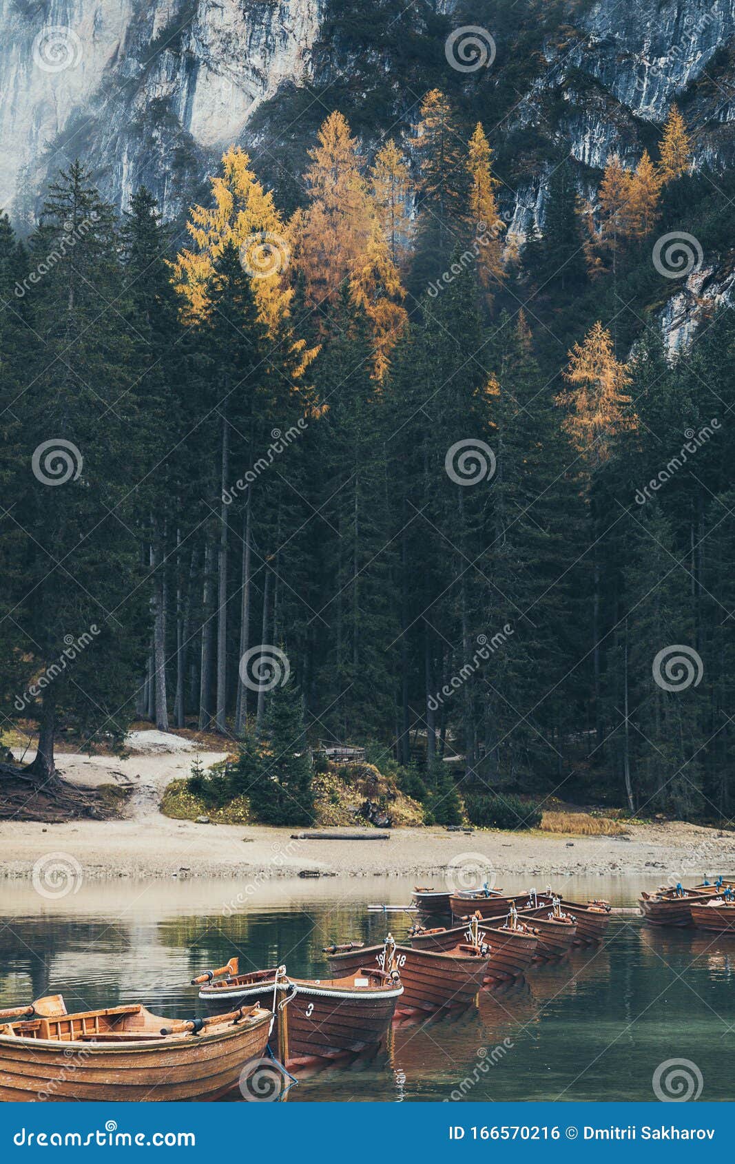 wooden boats on emerald lago di braies lake in dolomites