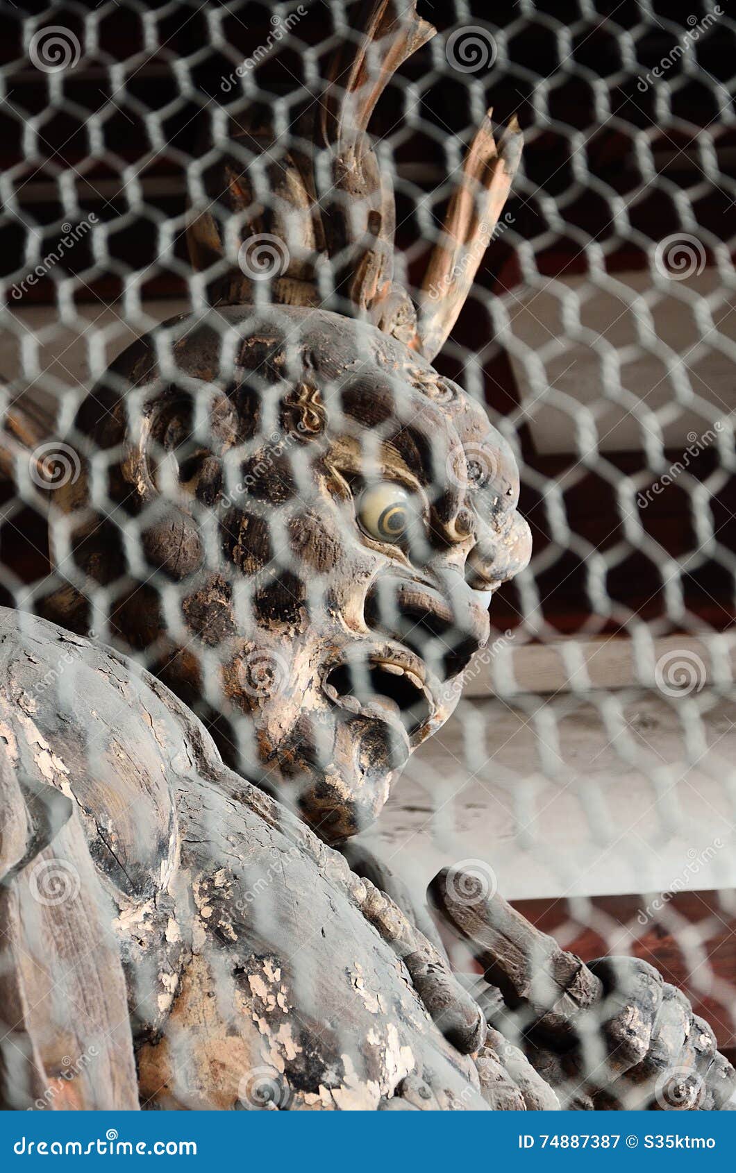 wooden buddha at temple in kyoto, japan