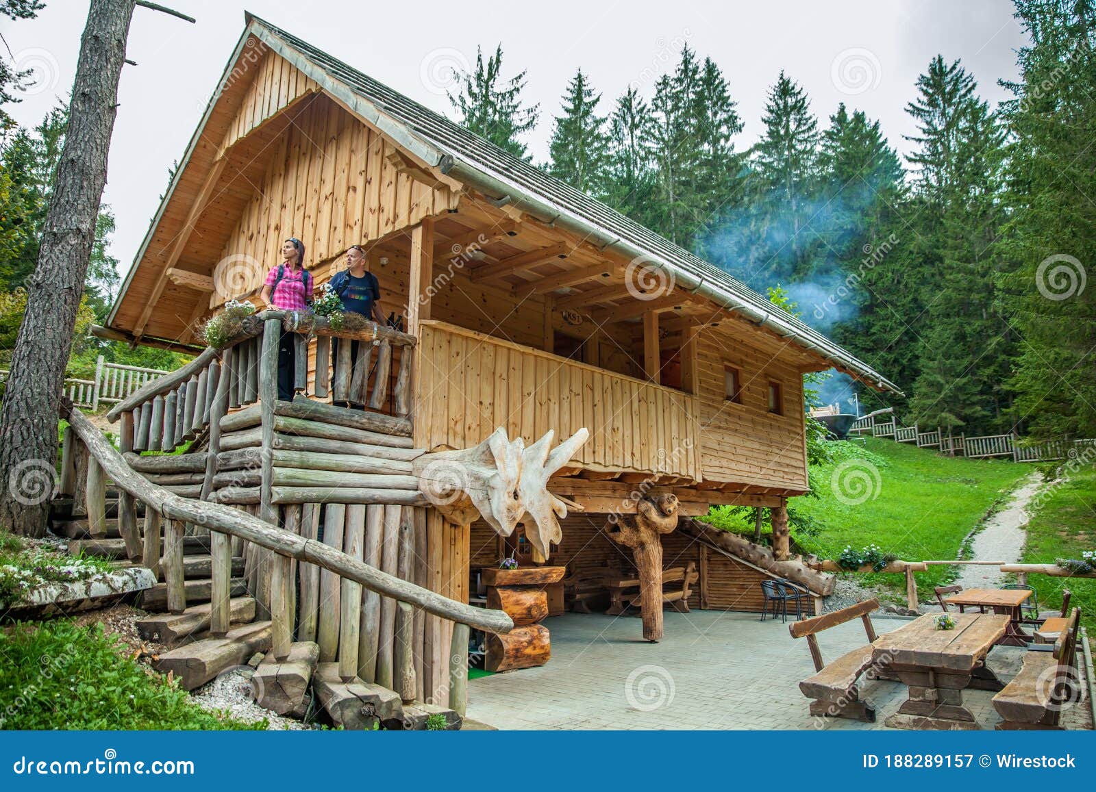 wooden cabin with tourists at hija glamping lake bloke in nova vas, slovenia