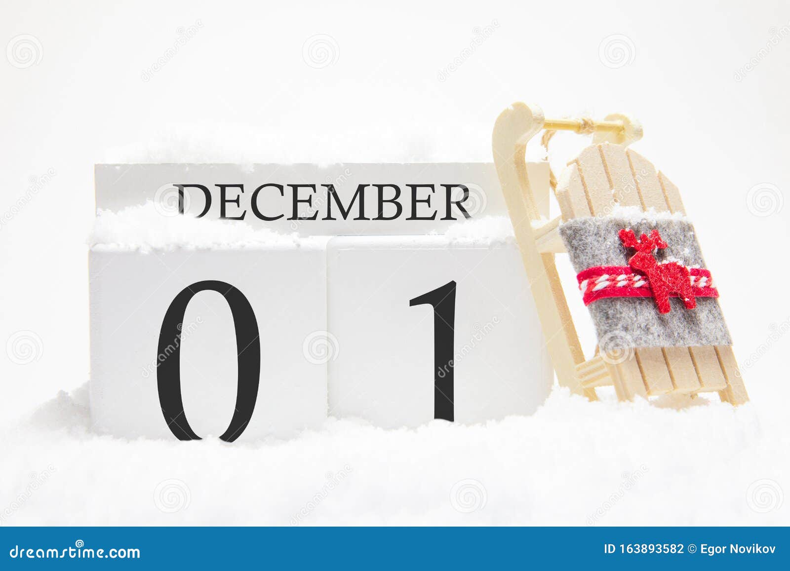 wooden calendar for december, 1 st day of the winter month. the s of winter are snow and sleigh. concept of holidays,