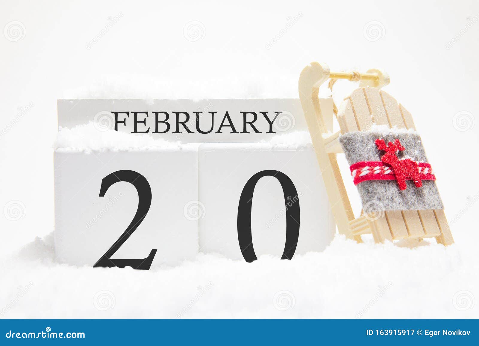 wooden calendar for february, 20 th day of the winter month. the s of winter are snow and sleigh. concept of holidays,