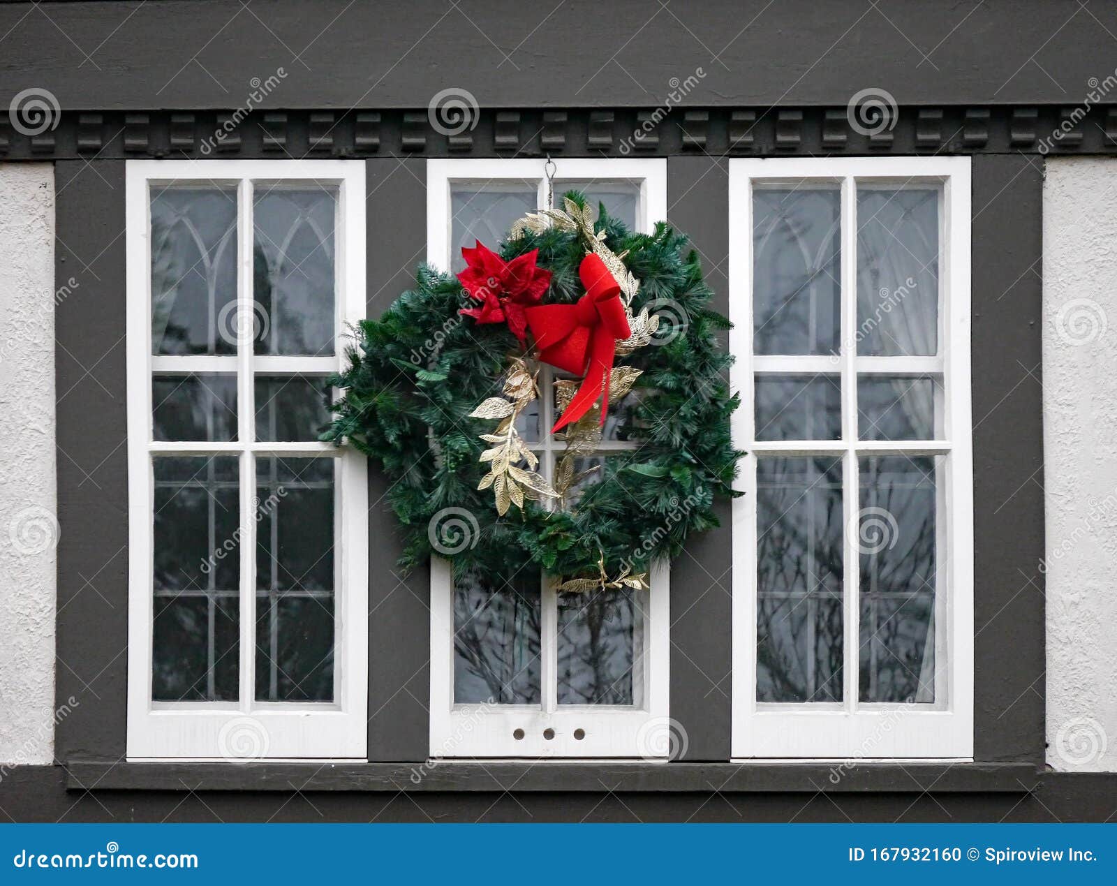 wooden casement window decorated with christmas wreath