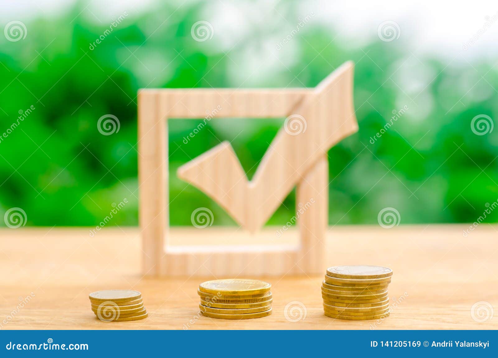 wooden check mark and stacks of coins. interest rates on deposits and loans. lobbying the adoption of regulations and laws.